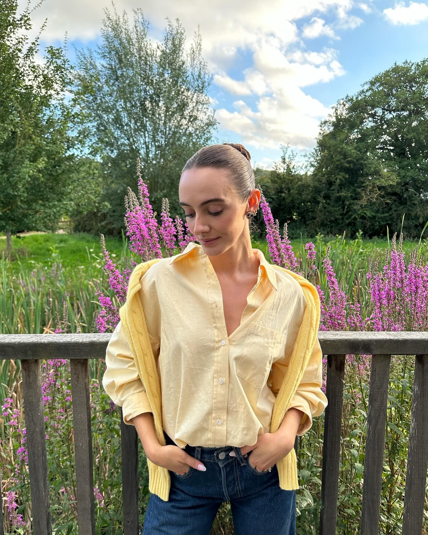 Liv Perez wearing a sweater draped over her shoulders and a collared shirt