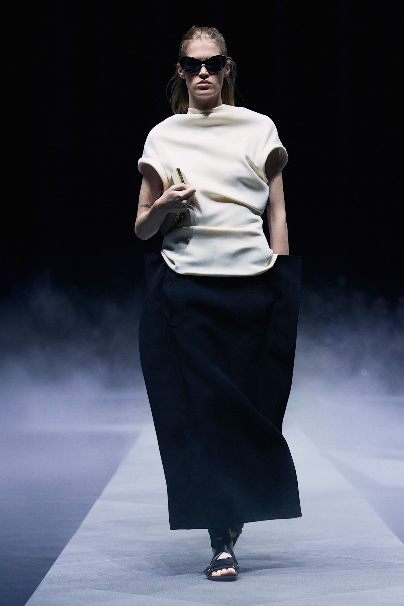 models at khaite holding clutches tight to their chest.