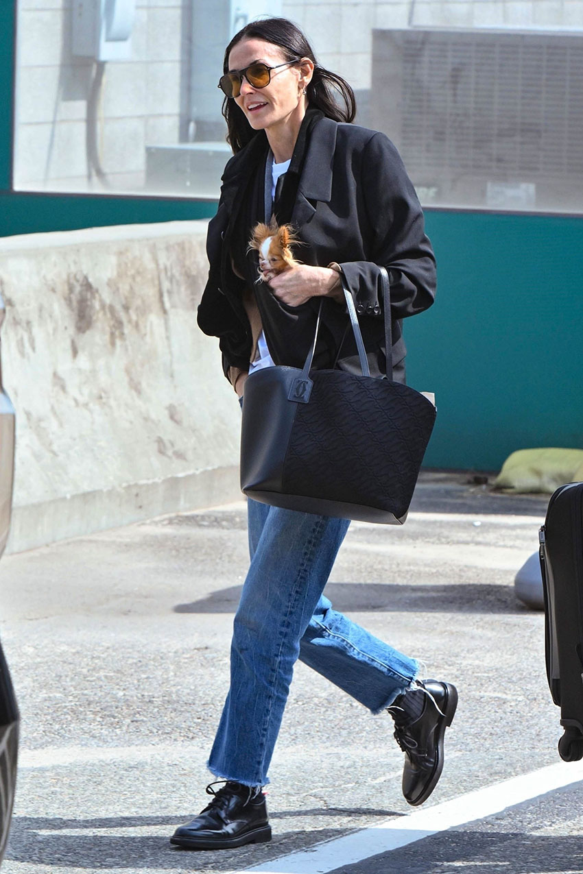 Demi Moore wearing a black blazer, jeans, and black derby shoes