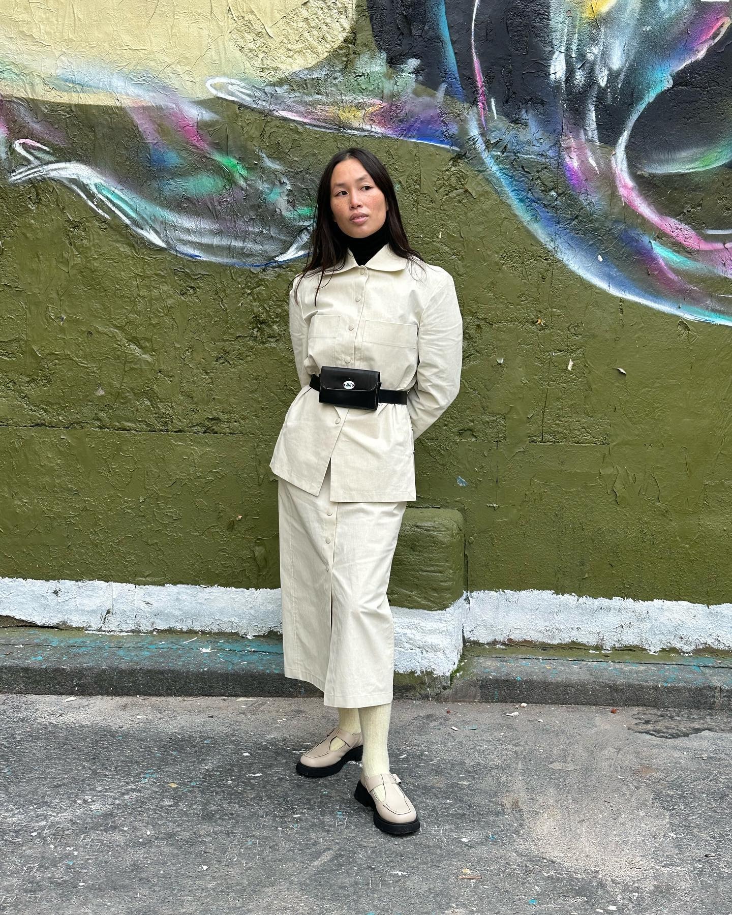 Influencer @vikilefevre wears a white jacket with a white skirt and white t-bar flats.