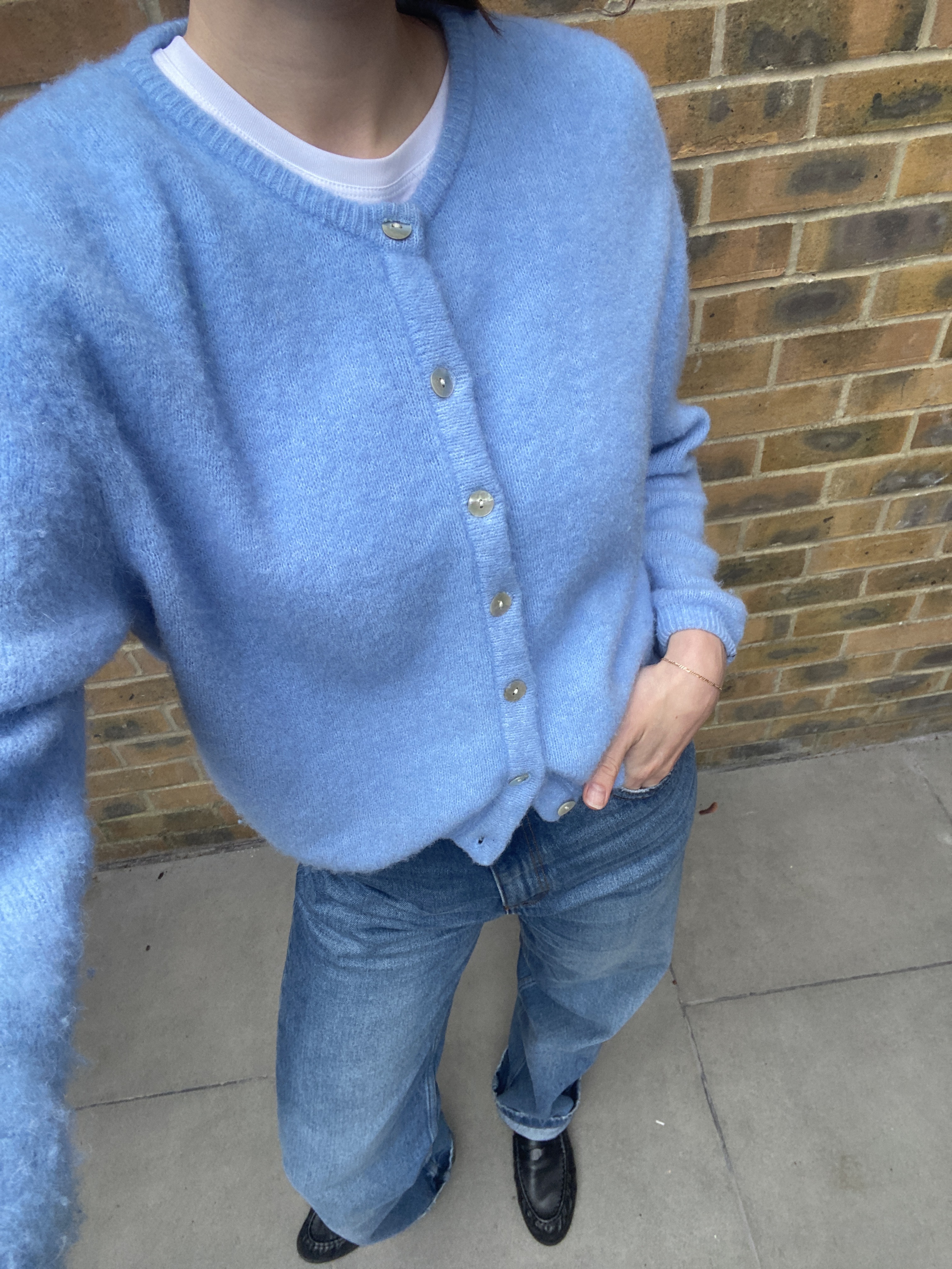 Who What Wear News Writer Natalie Munro wears a blue American Vintage cardigan with jeans.