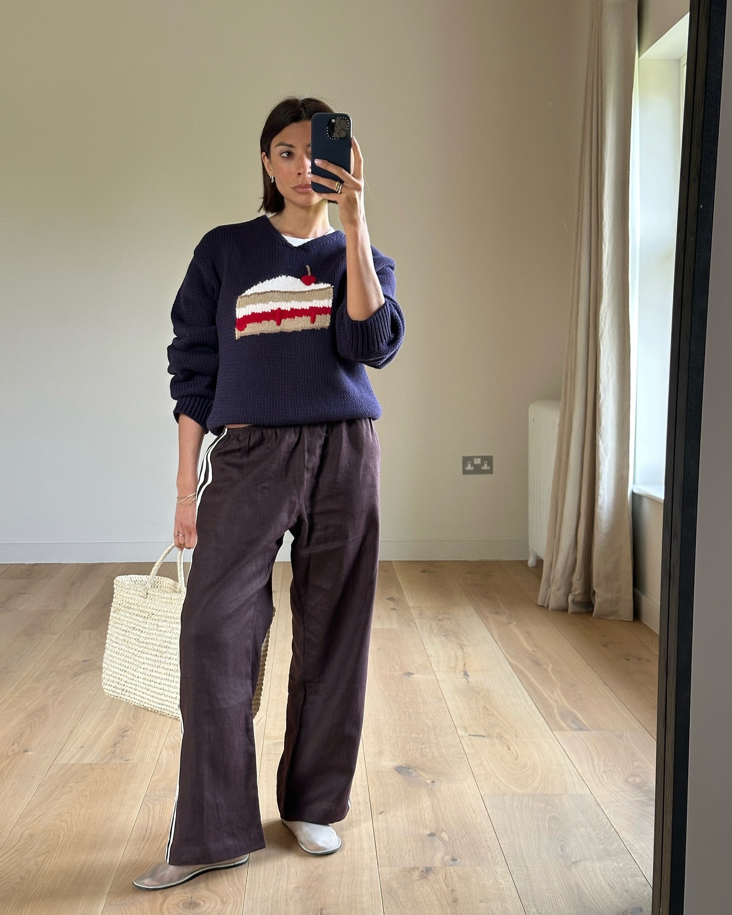 Influencer wearing track pants with a sweater and mesh flats