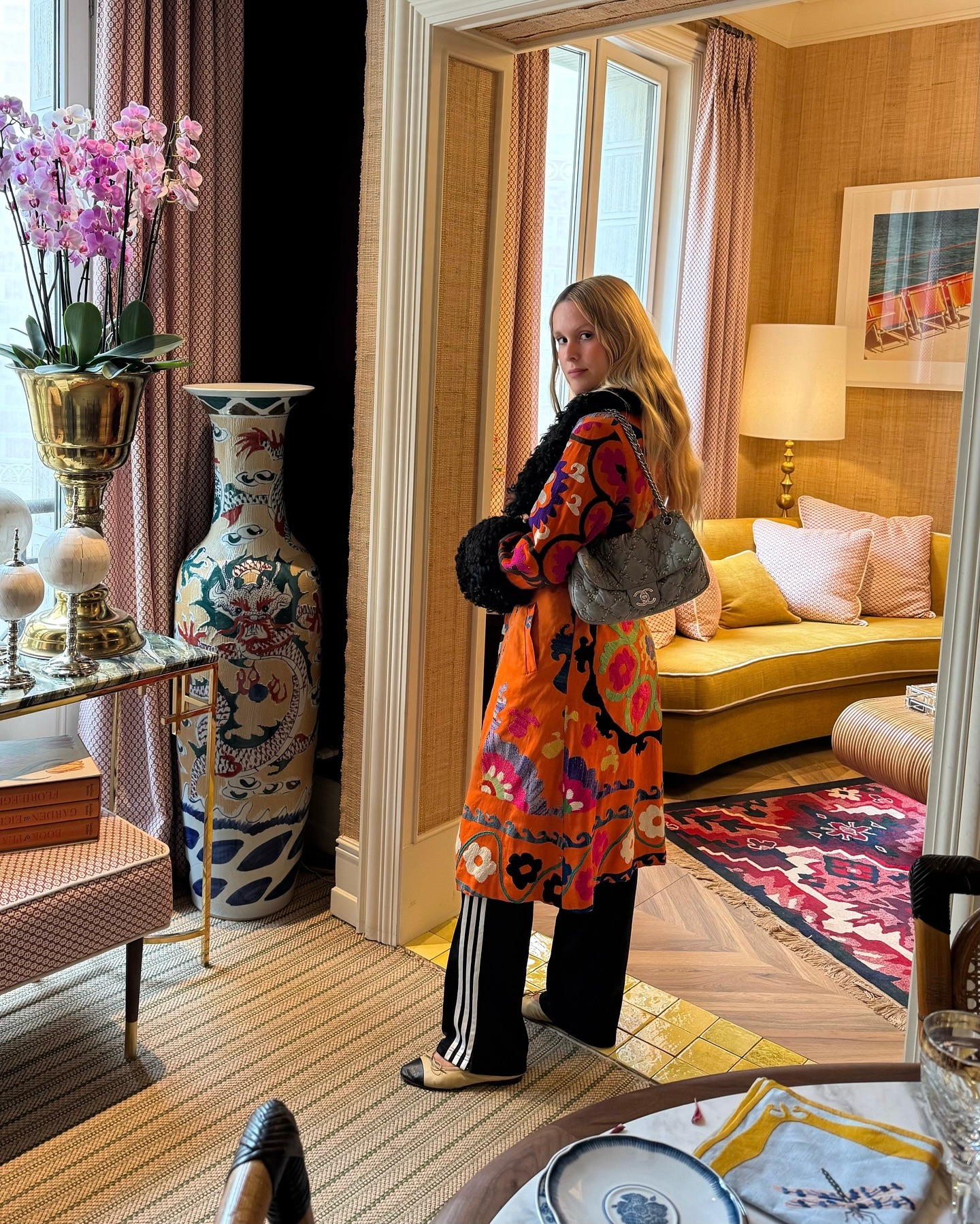 Influencer wearing track pants with a printed jacket and ballet flats