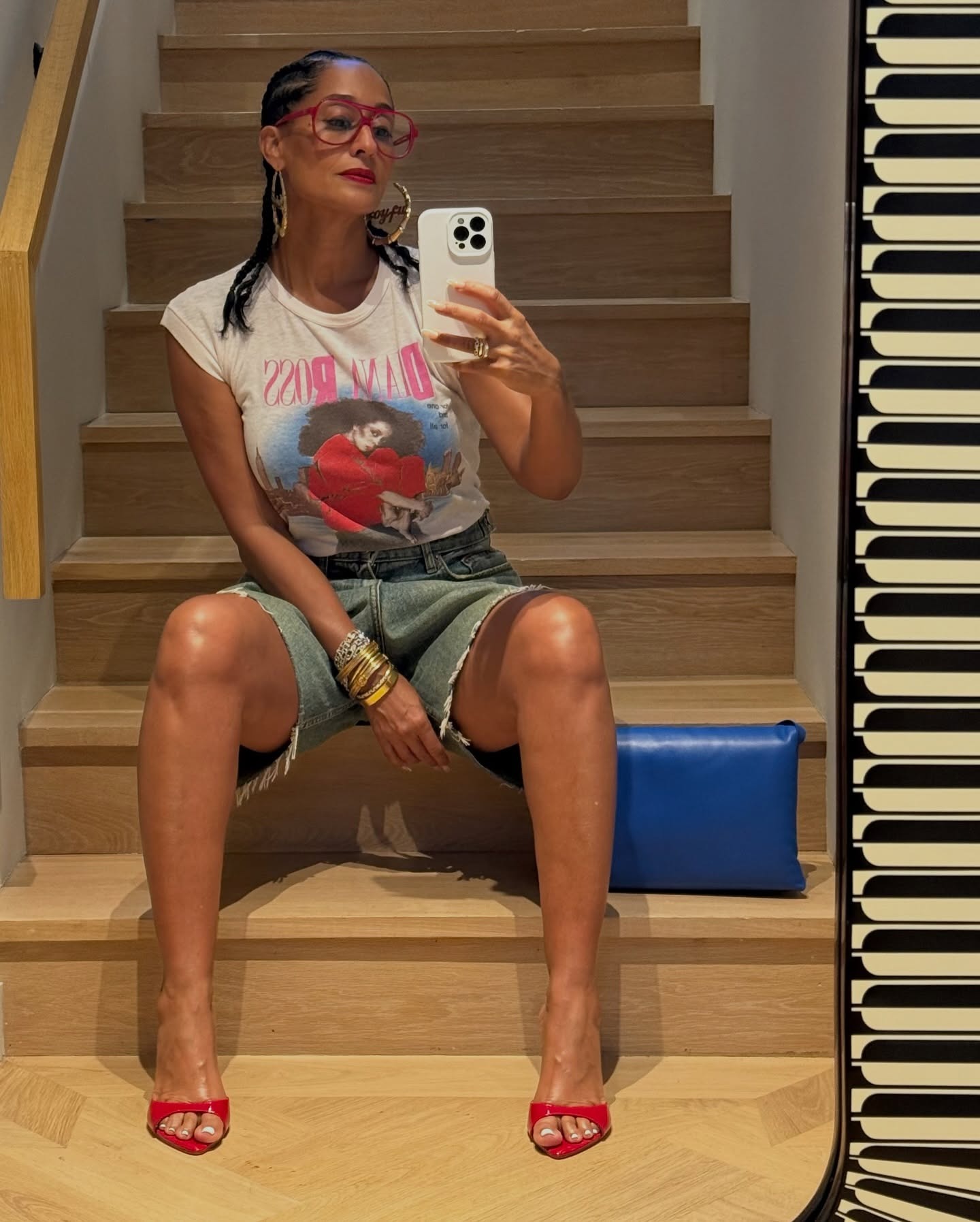 @traceeellisross wears red peep-toe shoes and blue denim shorts