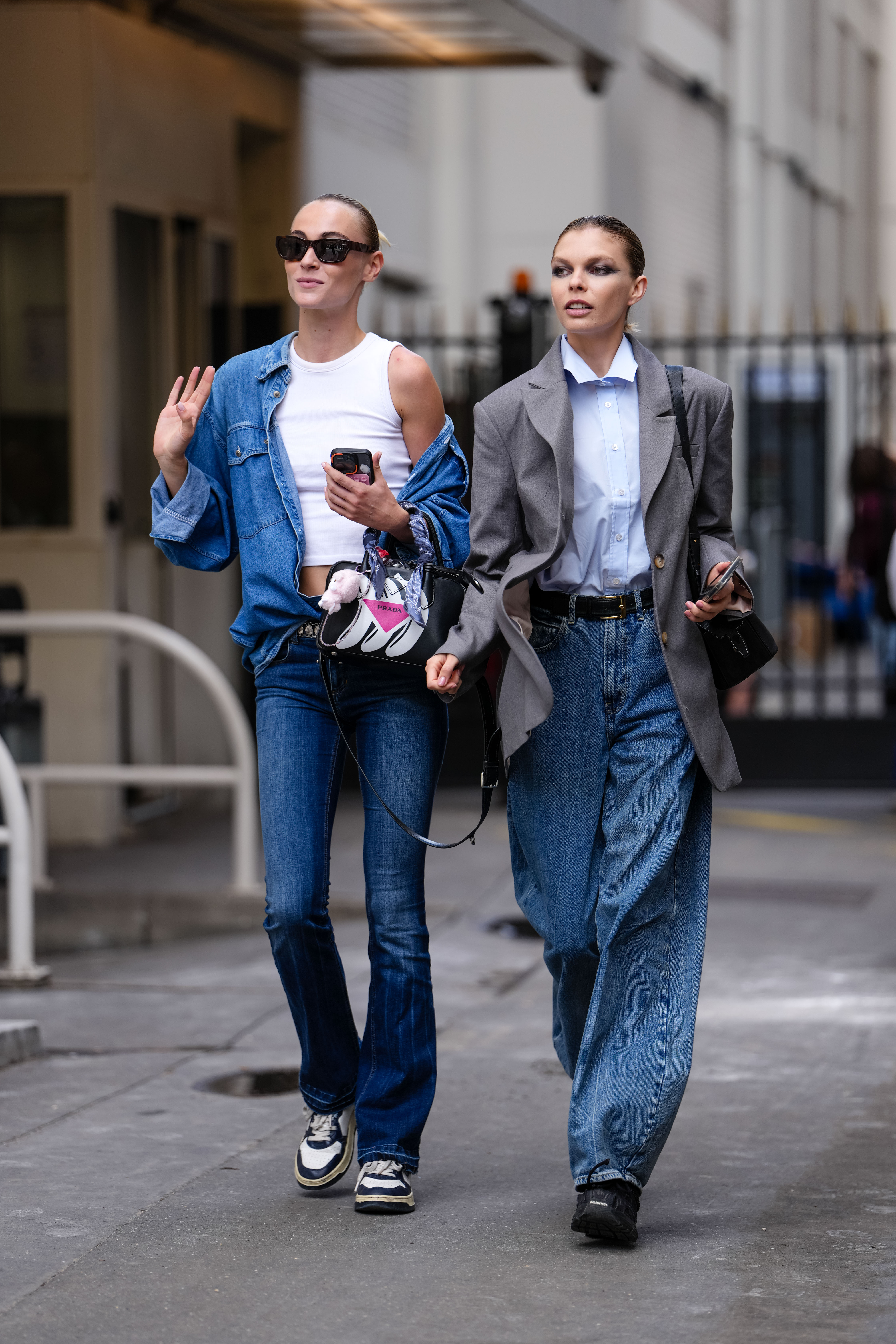 a street style photo of two women wearing jeans