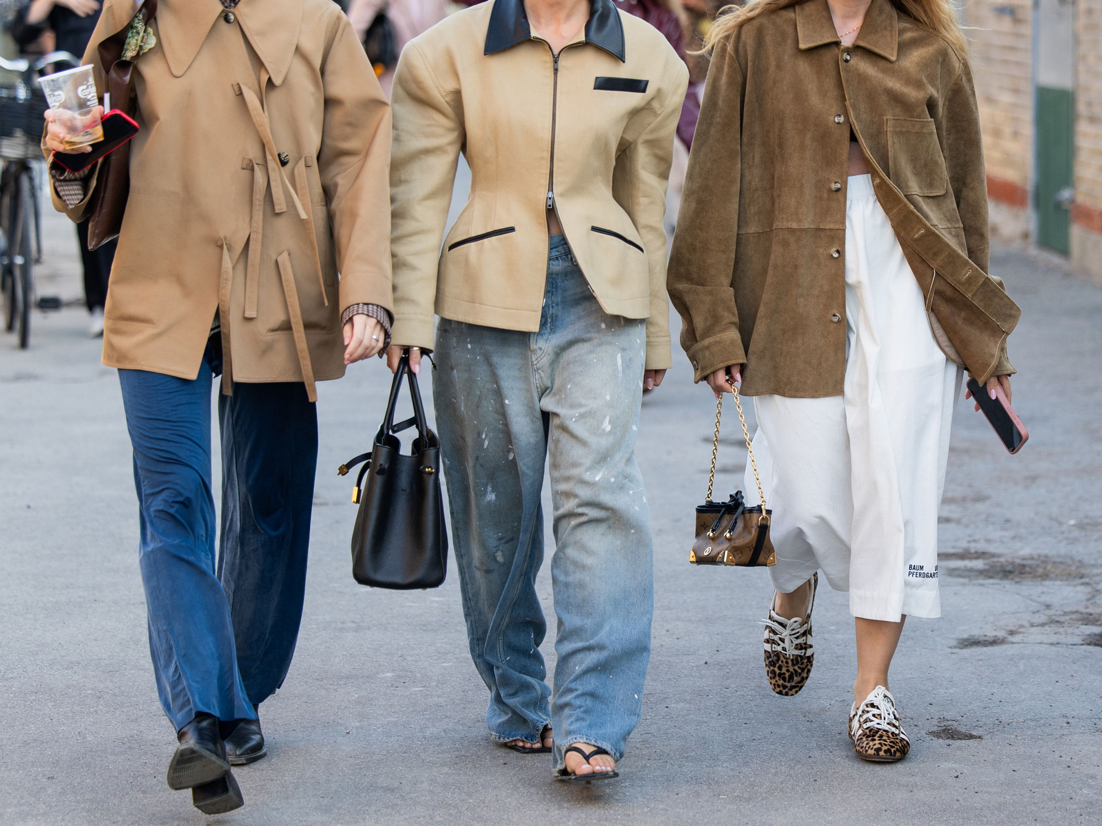 a group of three women wear different denim trends