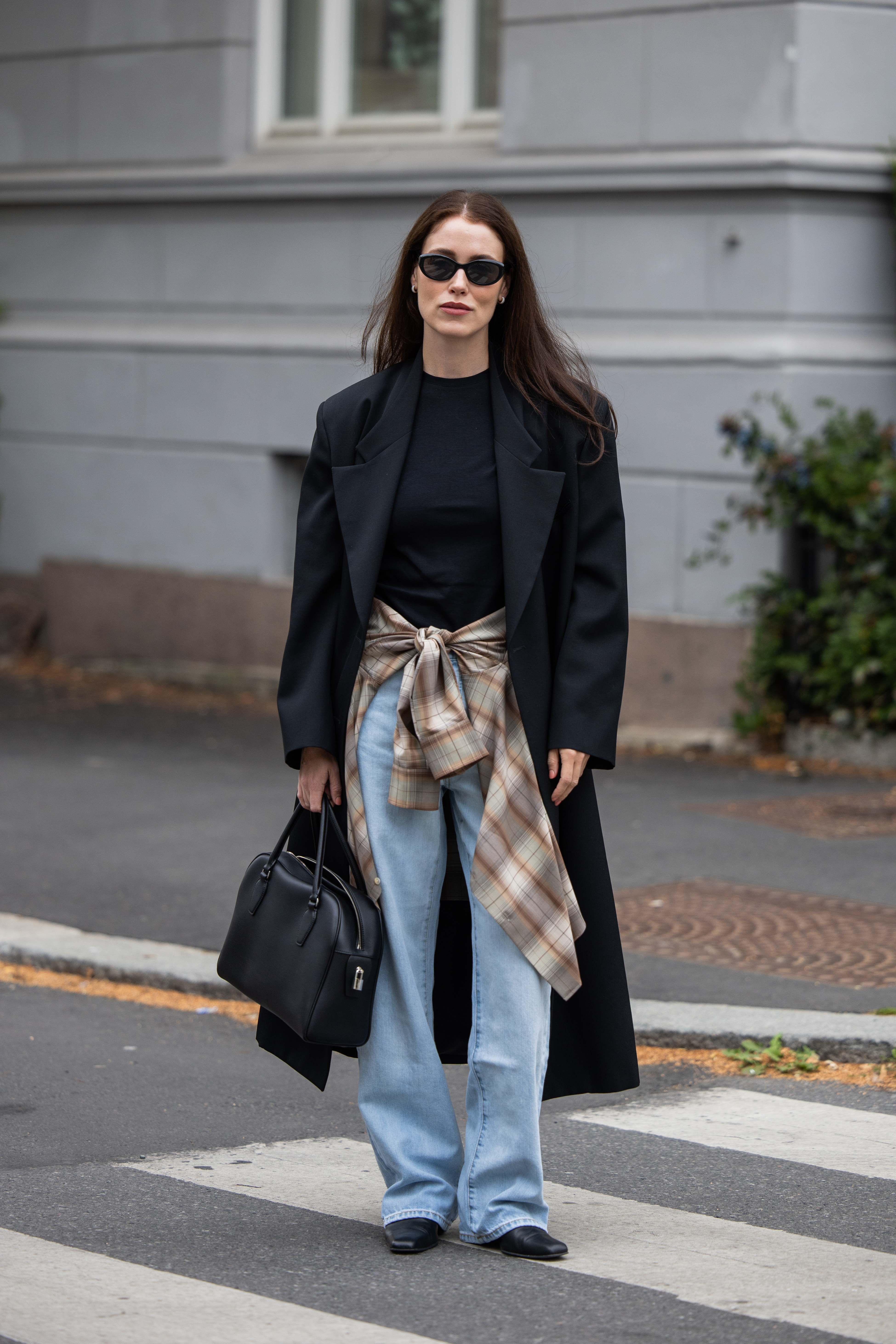 An image of Annabel Rosendahl wearing wide-leg jeans with a blazer and a flannel shirt.