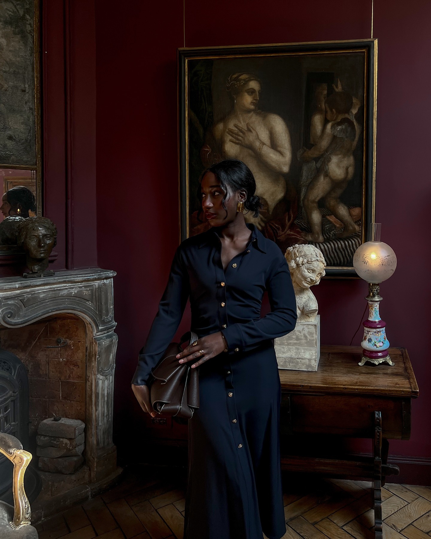 An image of a woman wearing all black and carrying a handbag.