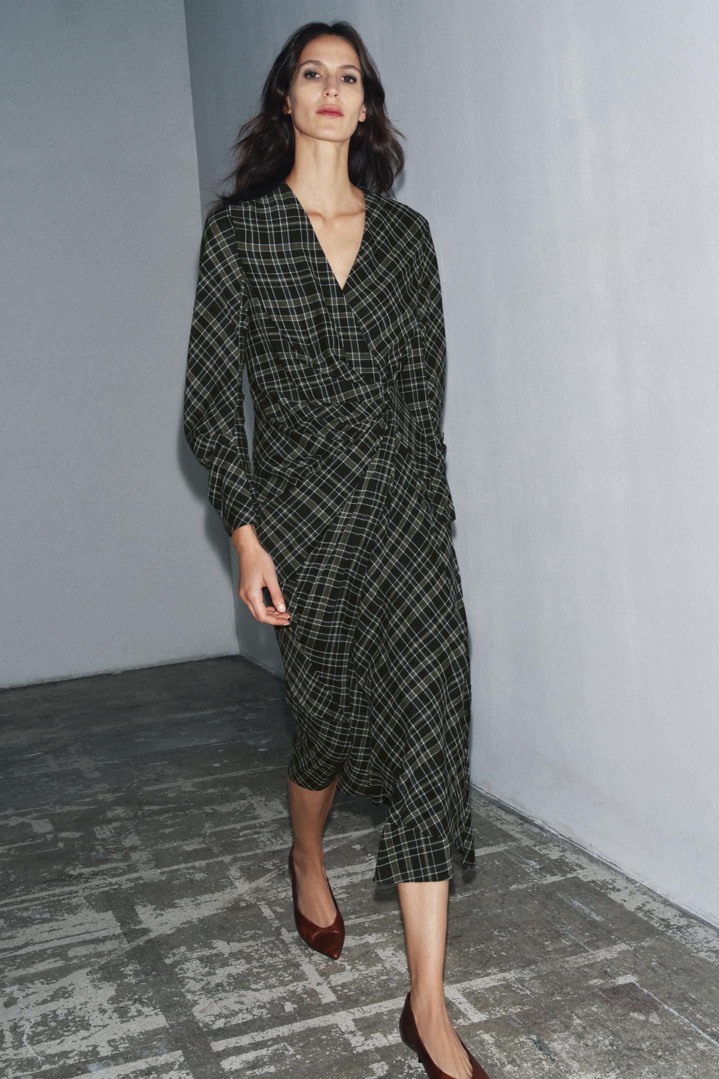 model wears draped plaid dress with brown kitten heels