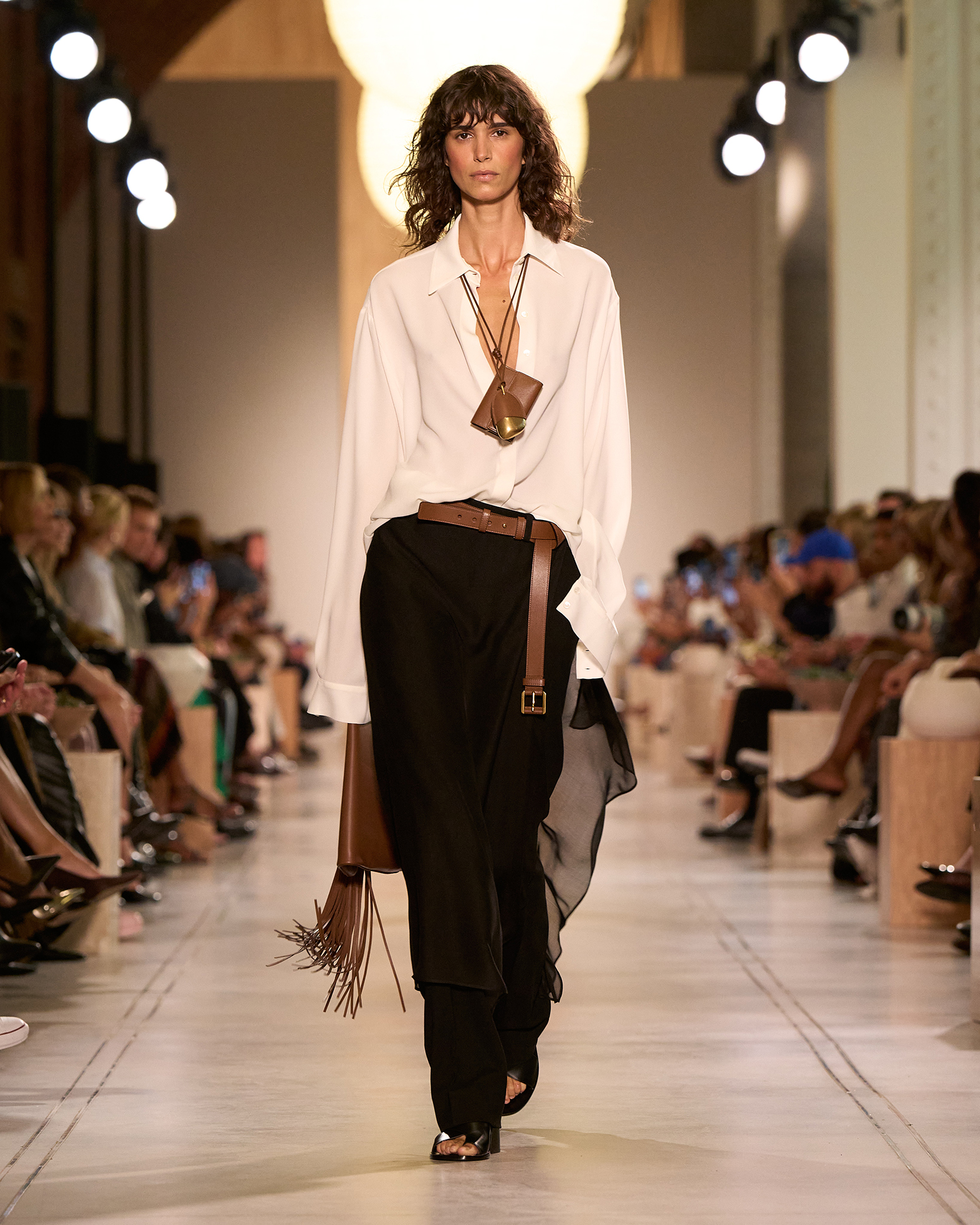 Michael Kors Spring/Summer 26 runway model wears white shirt black trousers
