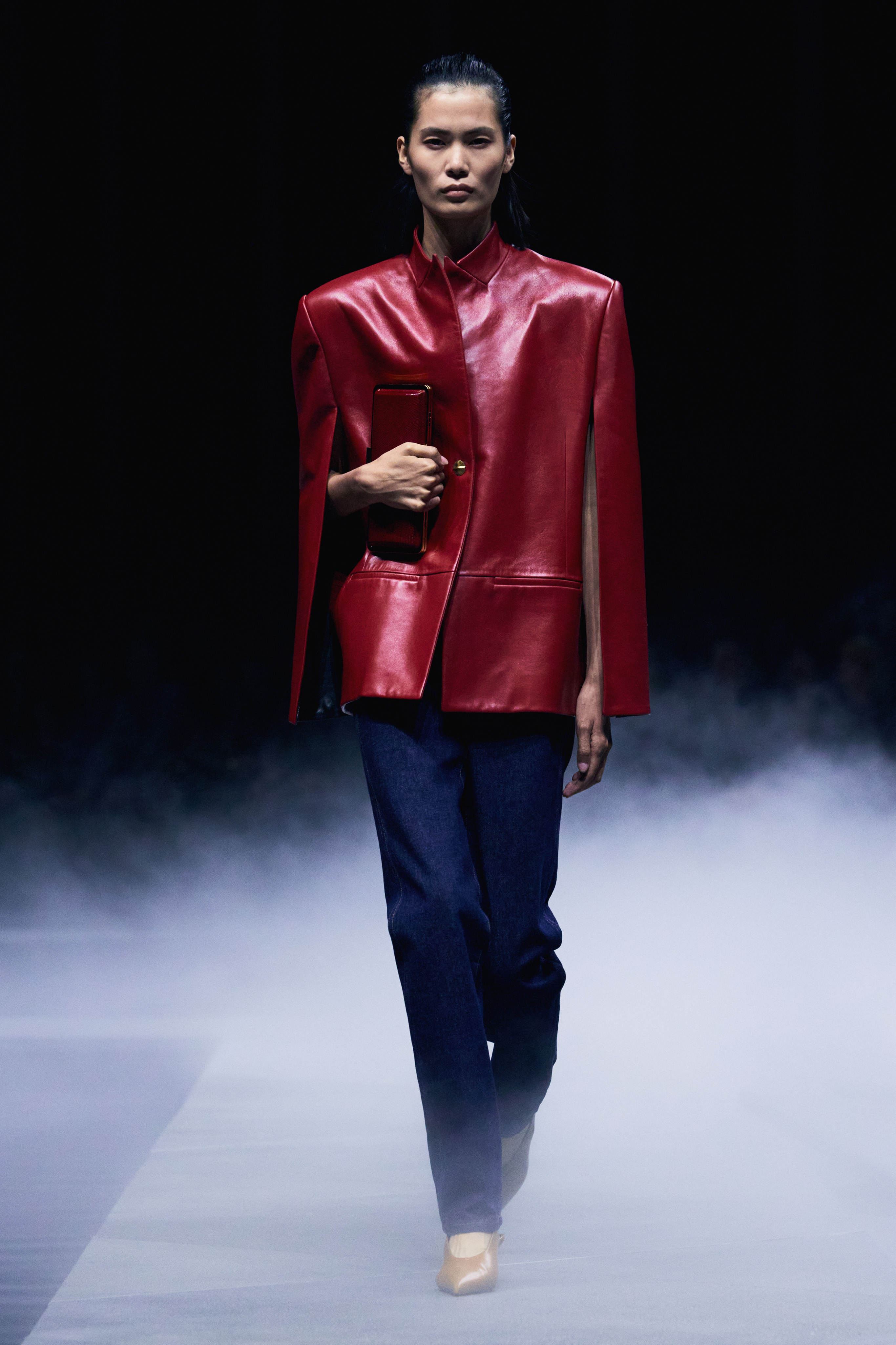 Khaite Spring/Summer 26 runway model wears jeans and red leather blazer