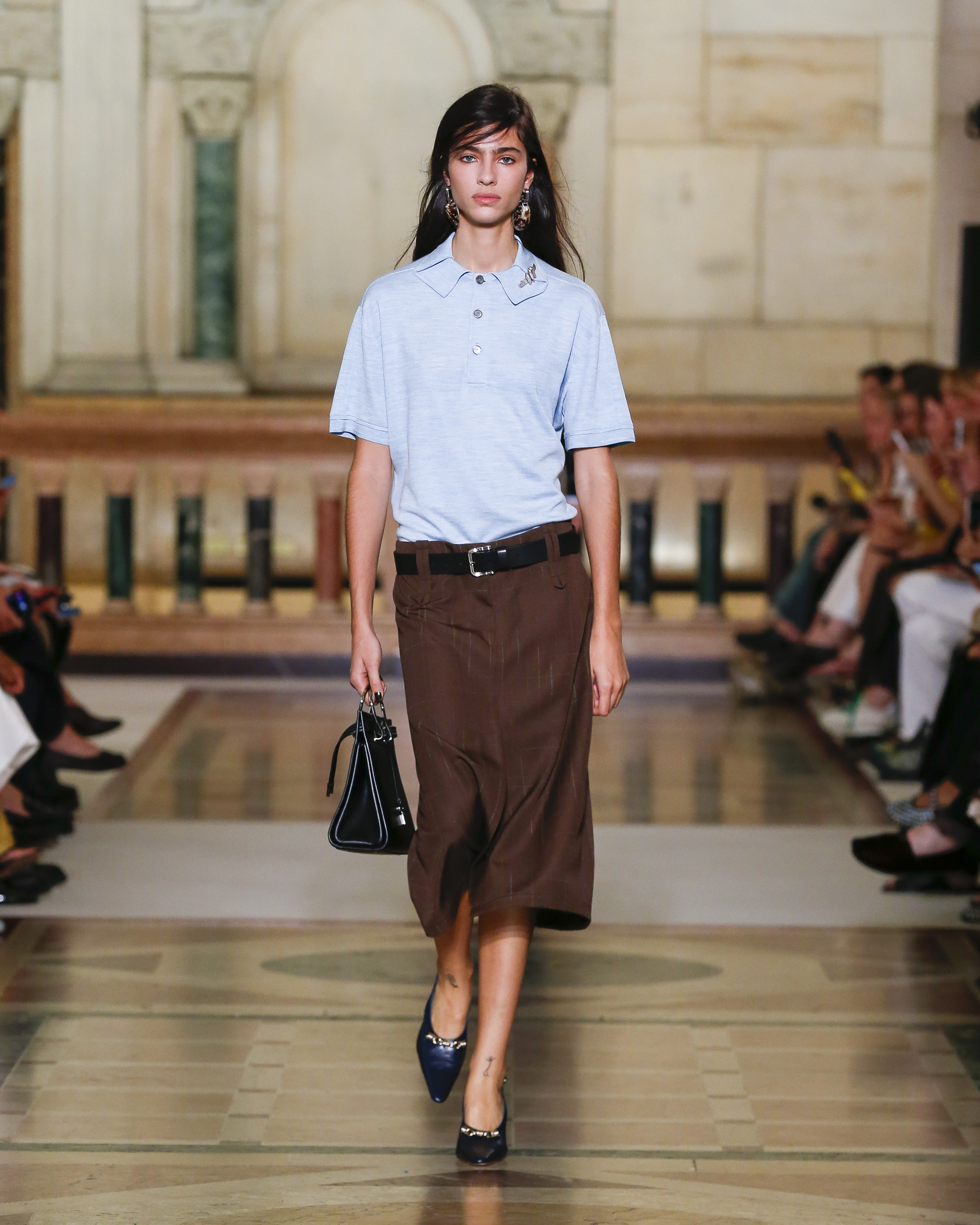 Tory Burch Spring/Summer 26 runway model wears blue polo brown skirt