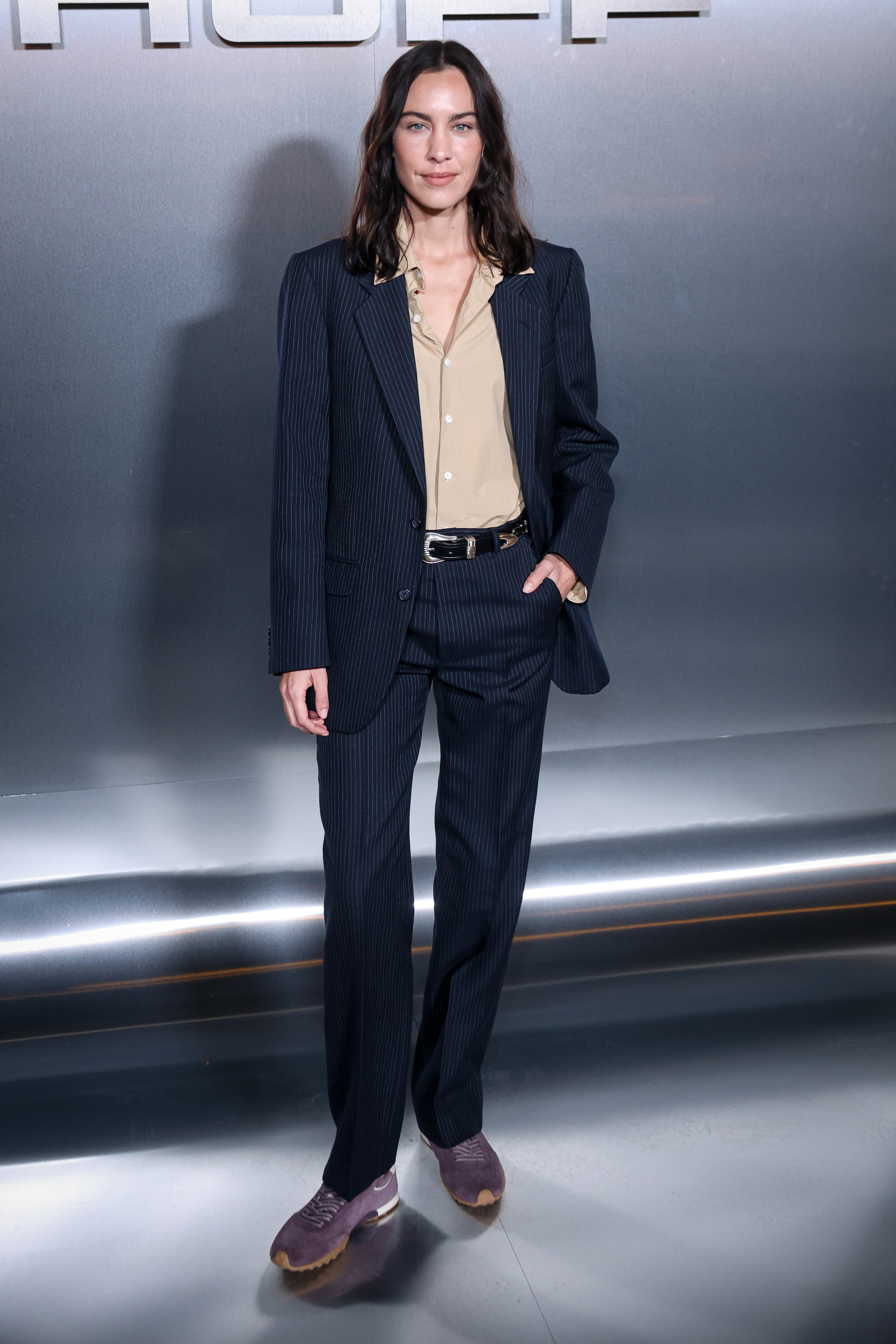 Alexa Chung wears a navy pinstripe suit with dark purple slim-line Hoff Trainers.