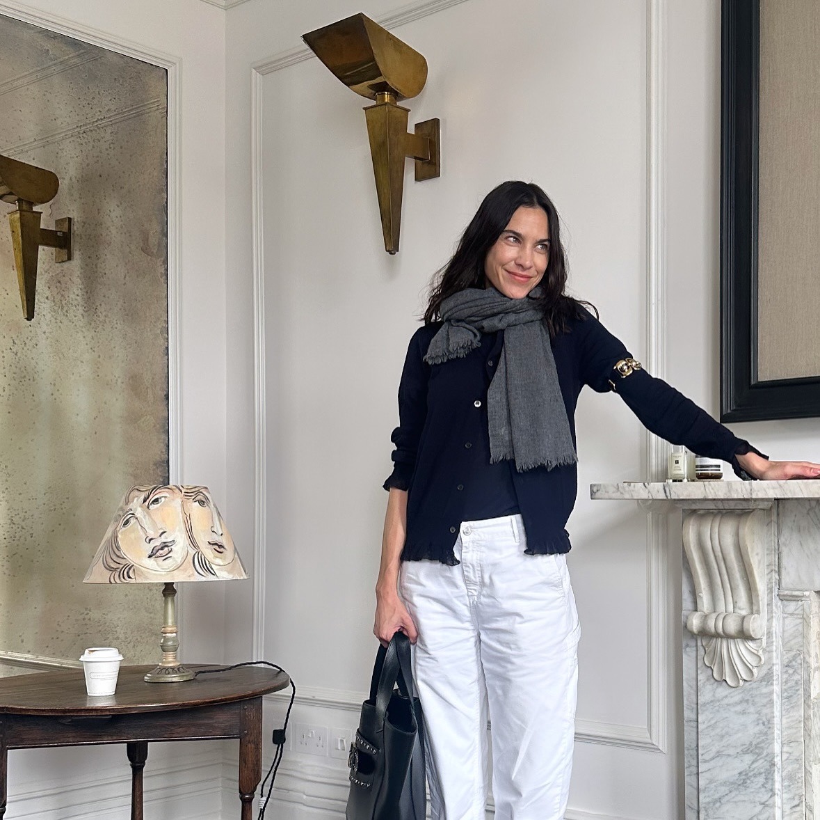 Alexa Chung wears an orange top with a brown pencil skirt