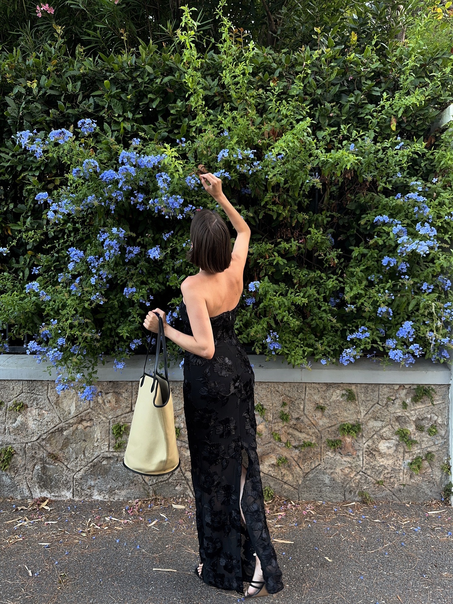 Photo of creator @maryljean outside smelling flowers