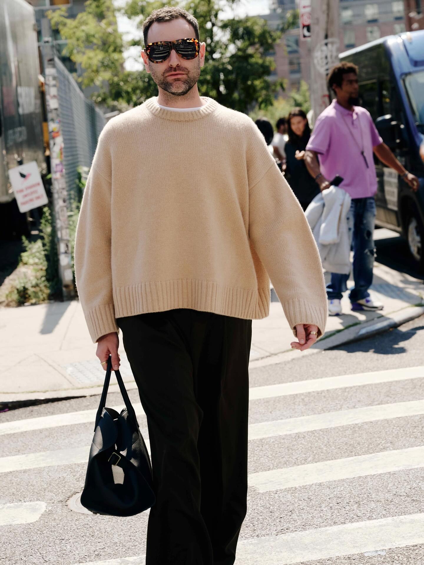 Who What Wear editor Bobby Schuessler wears COS Chunky Cashmere Sweater during New York Fashion Week
