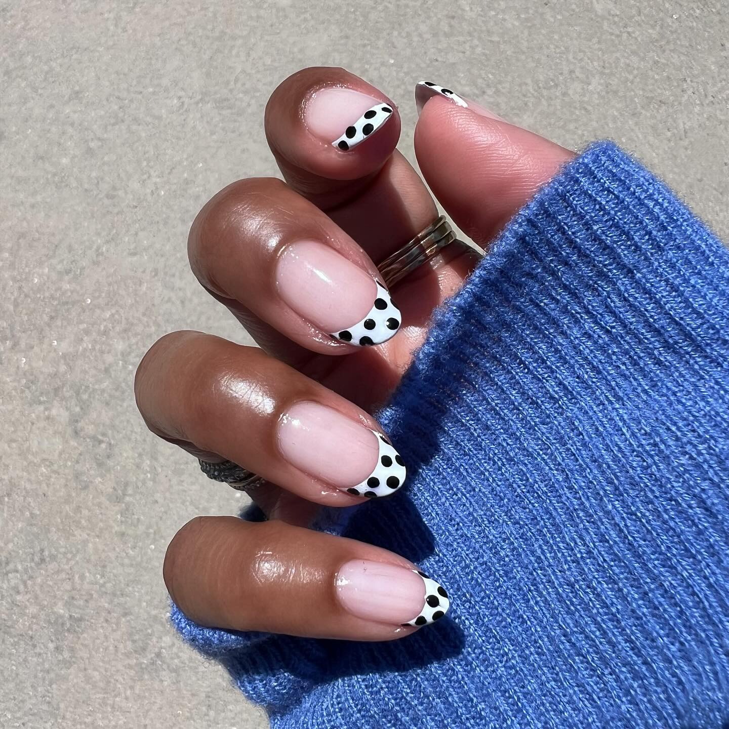 A monochrome polka dot French tip nail design