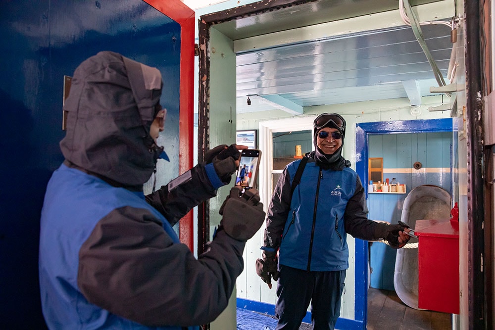 A tourist posts a letter at Port Lockroy