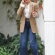 Jennifer Lopez wears high-waisted flares jeans with platform heels, a ruffle blouse and a beige blazer.