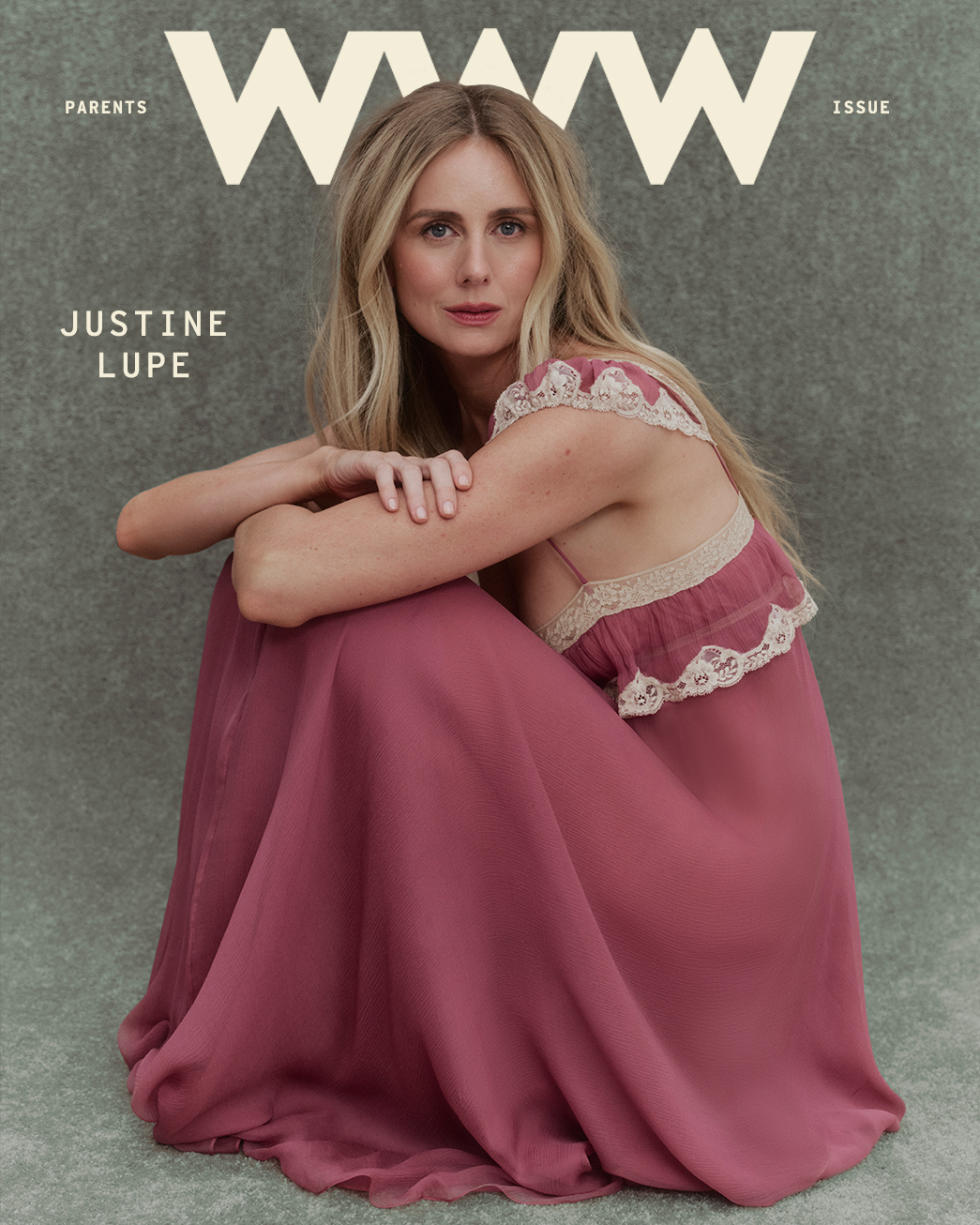 Justine Lupe crouching wearing a rose-colored and lace Chlo&amp;eacute; dress in front of a gray background