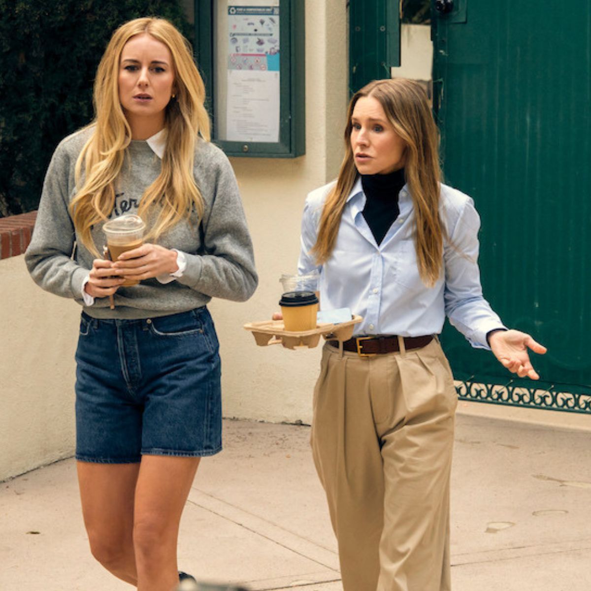 Kristen Bell wearing a blue shirt, beige trousers and black roll-neck.