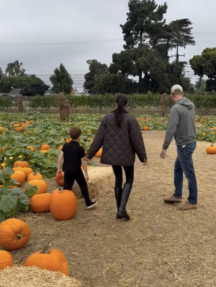 Meghan Markle visits a pumpkin patch wearing knee-high riding boots and skinny jeans