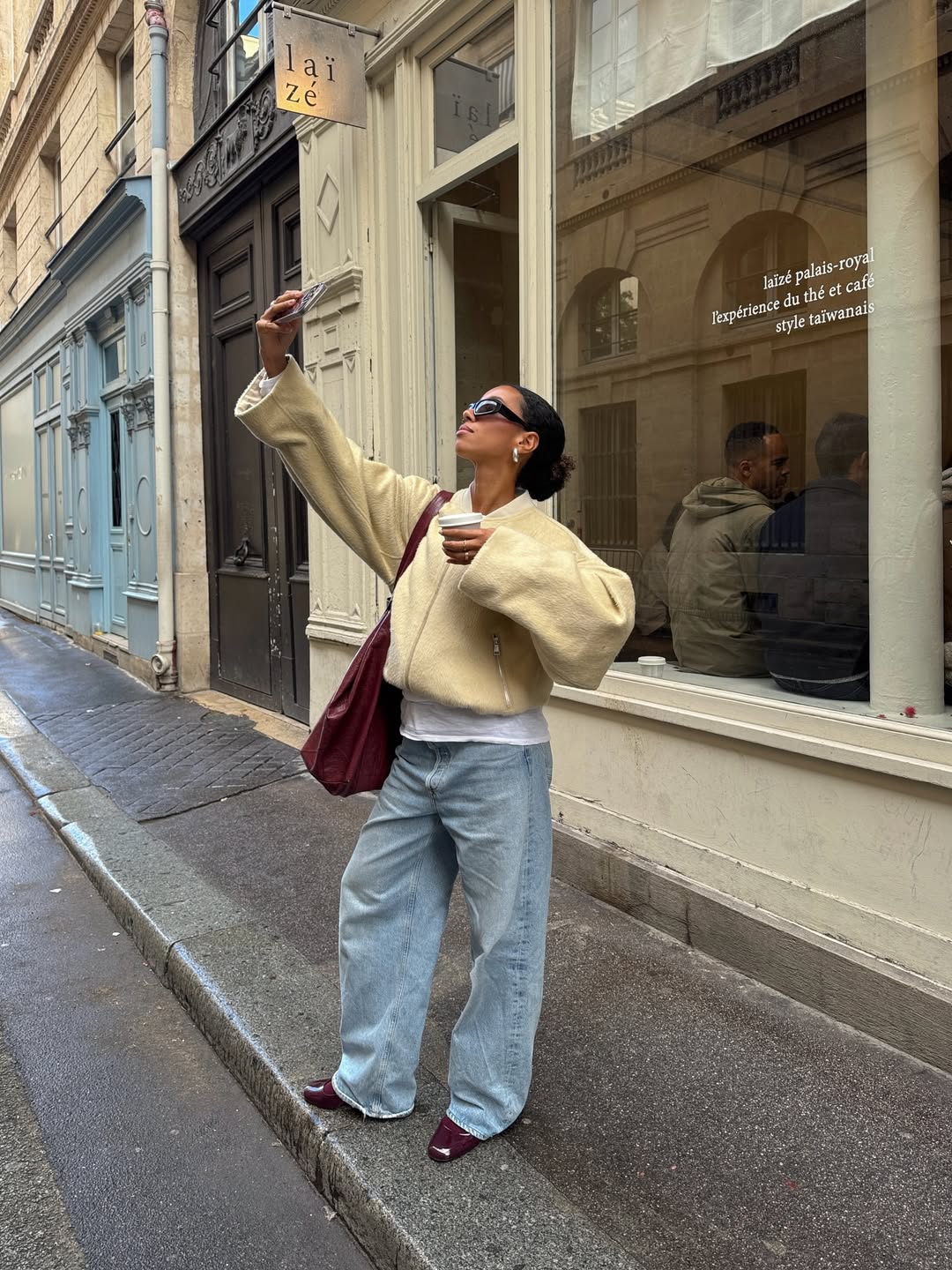 Influencer Amaka Hamelijnck wearing a wool bomber jacket and barrel leg jeans