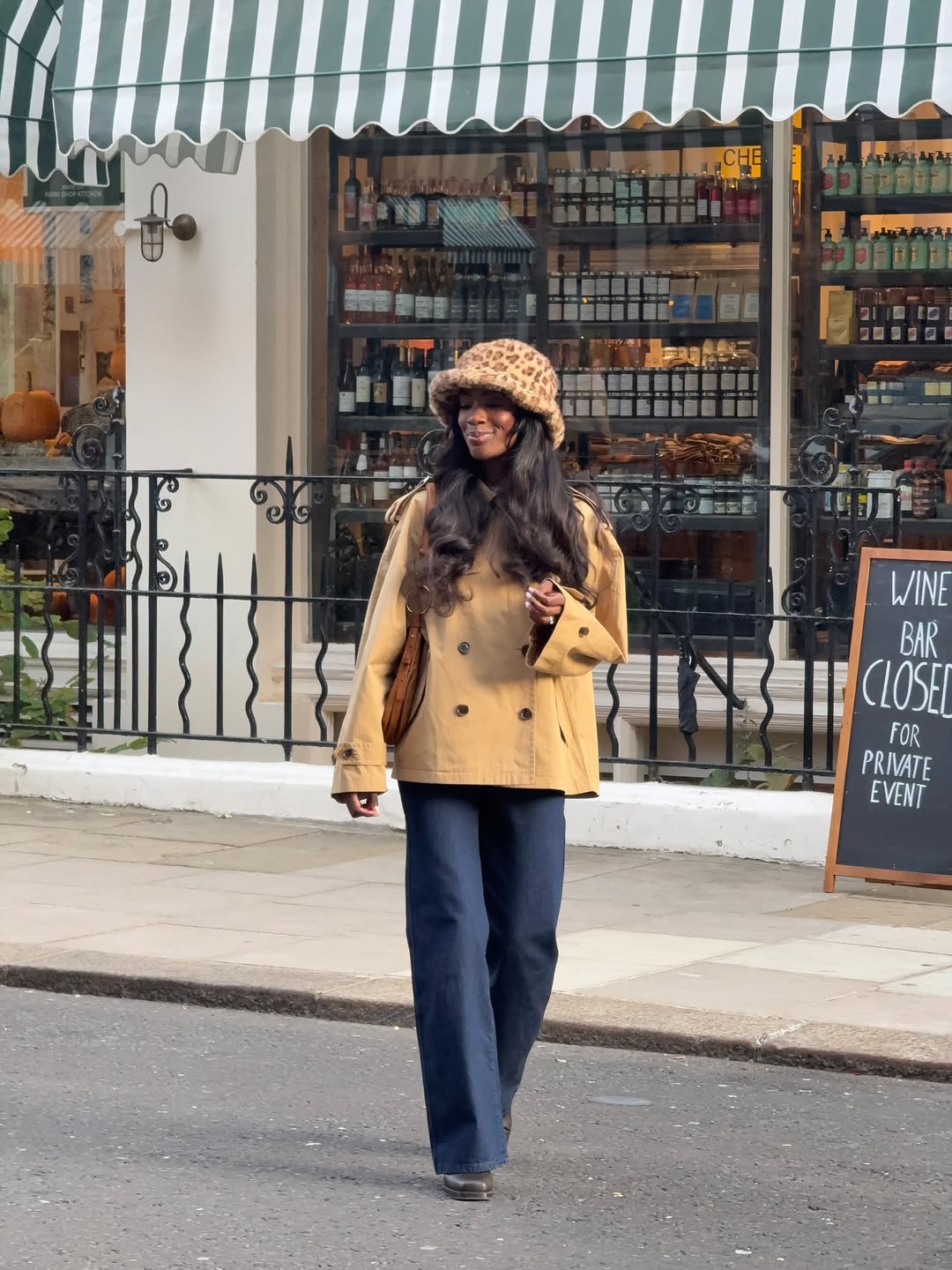 Influencer Liv Madeline wearing a cropped trench coat and flared jeans