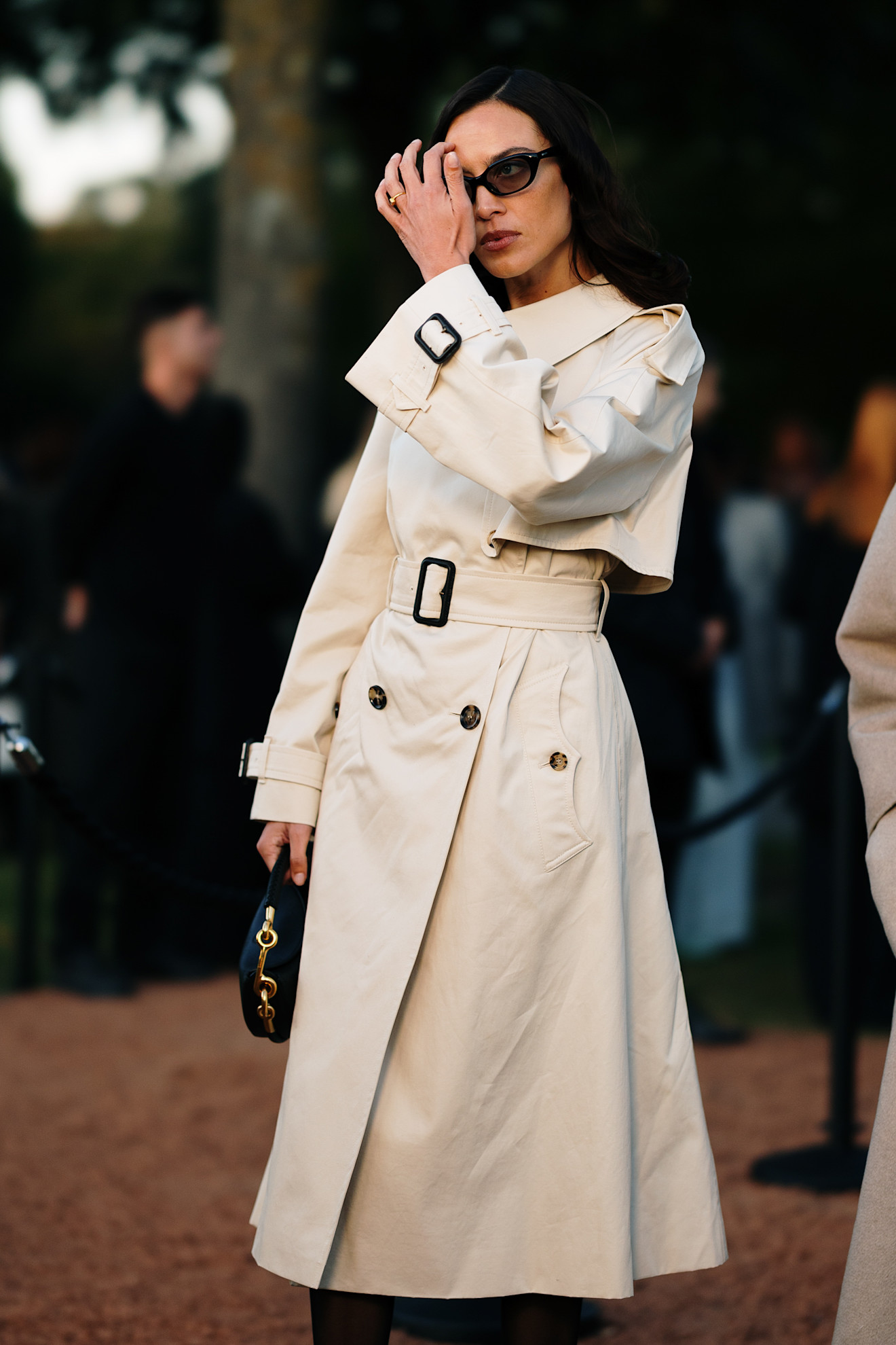 Woman in a trench coat at London Fashion Week S/S 26.