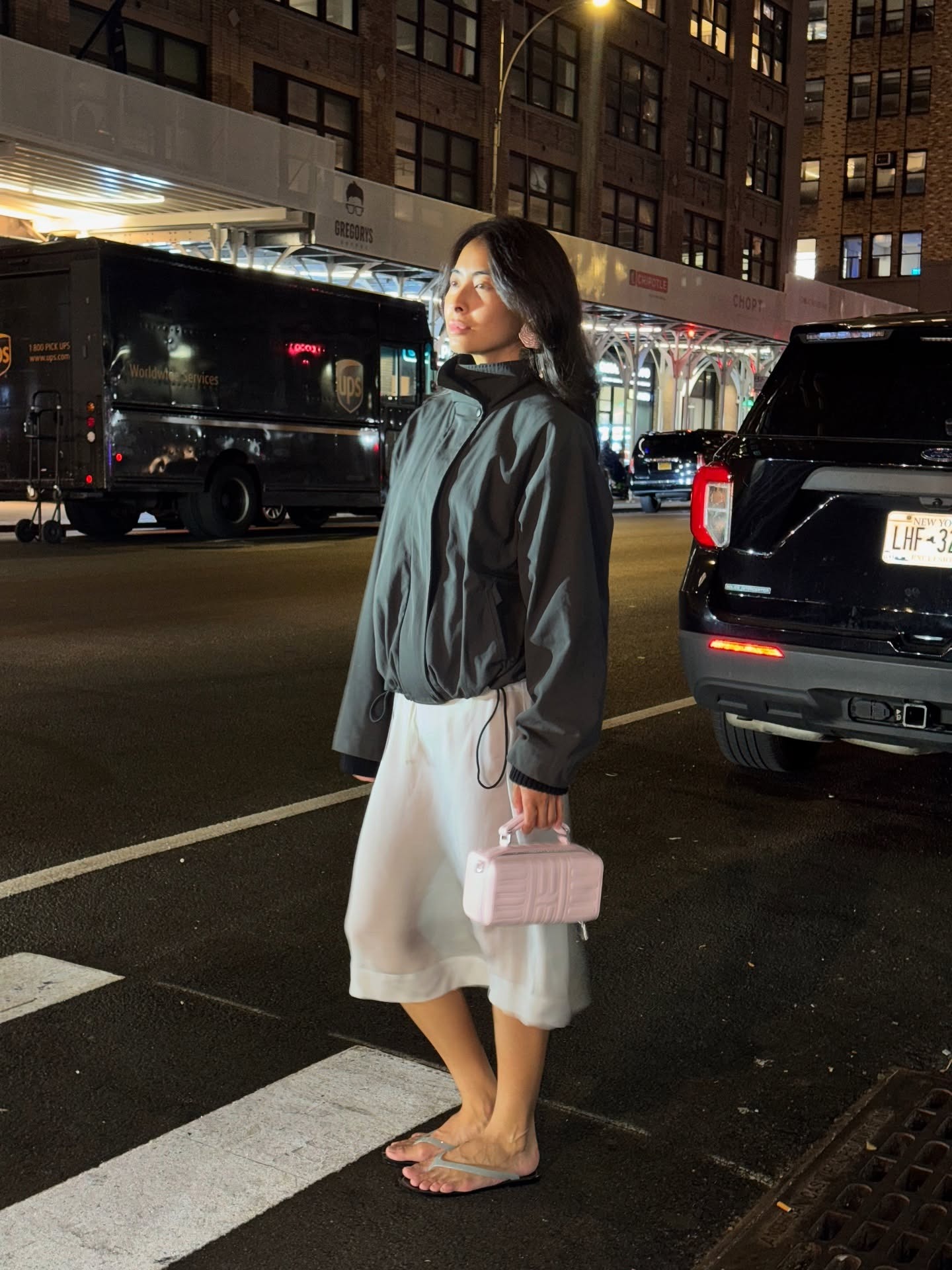 Michelle Li wears a Rimowa handbag