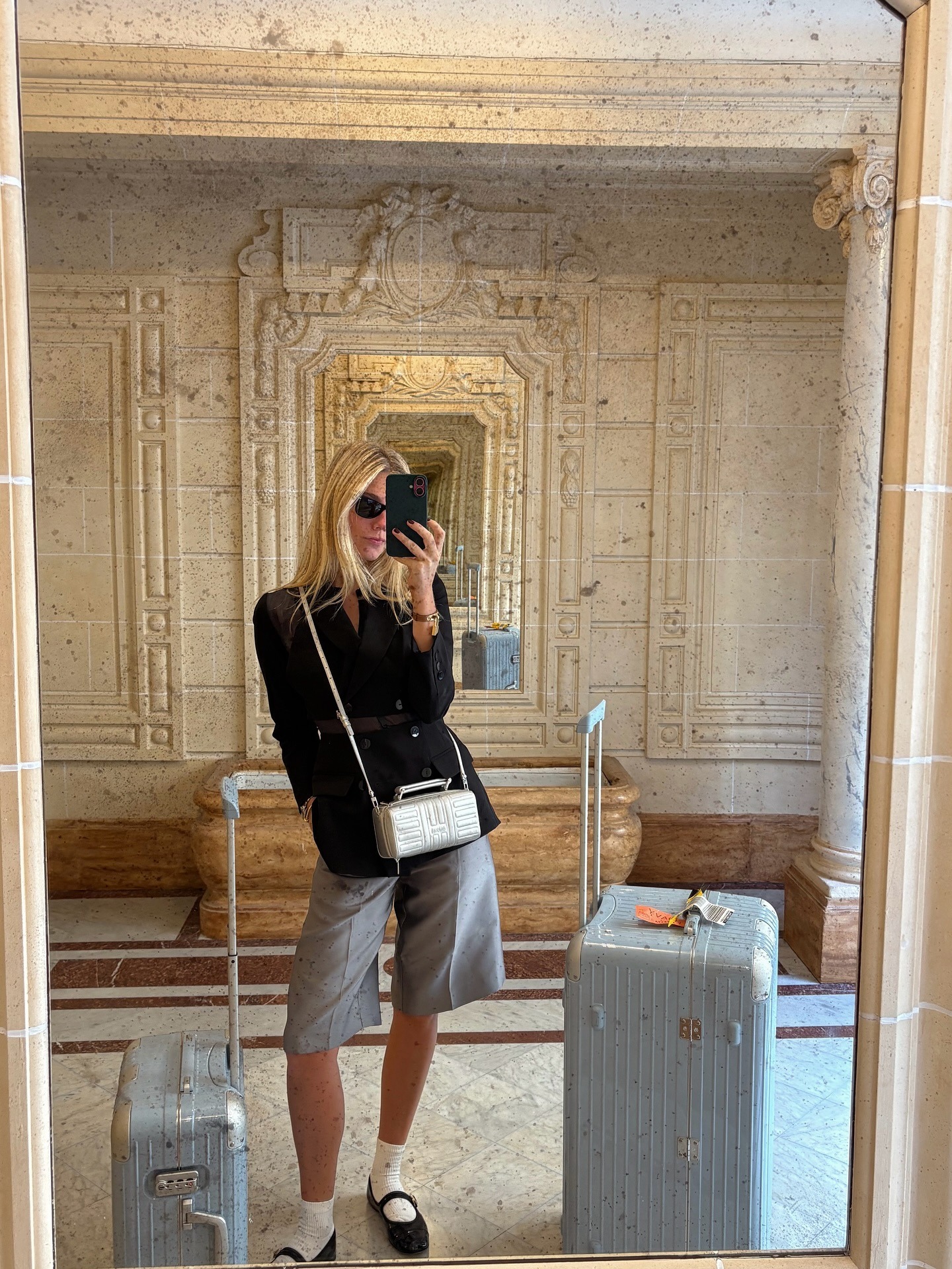 Lilly Sisto wears a Rimowa bag