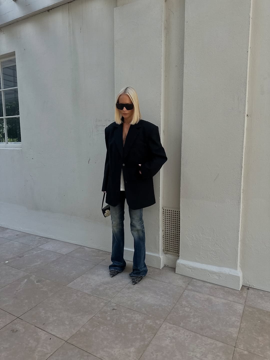 woman wearing fall dirty denim trend 2025