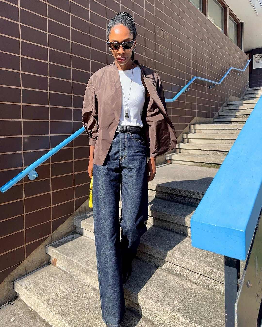 woman wearing fall dark denim trend 2025