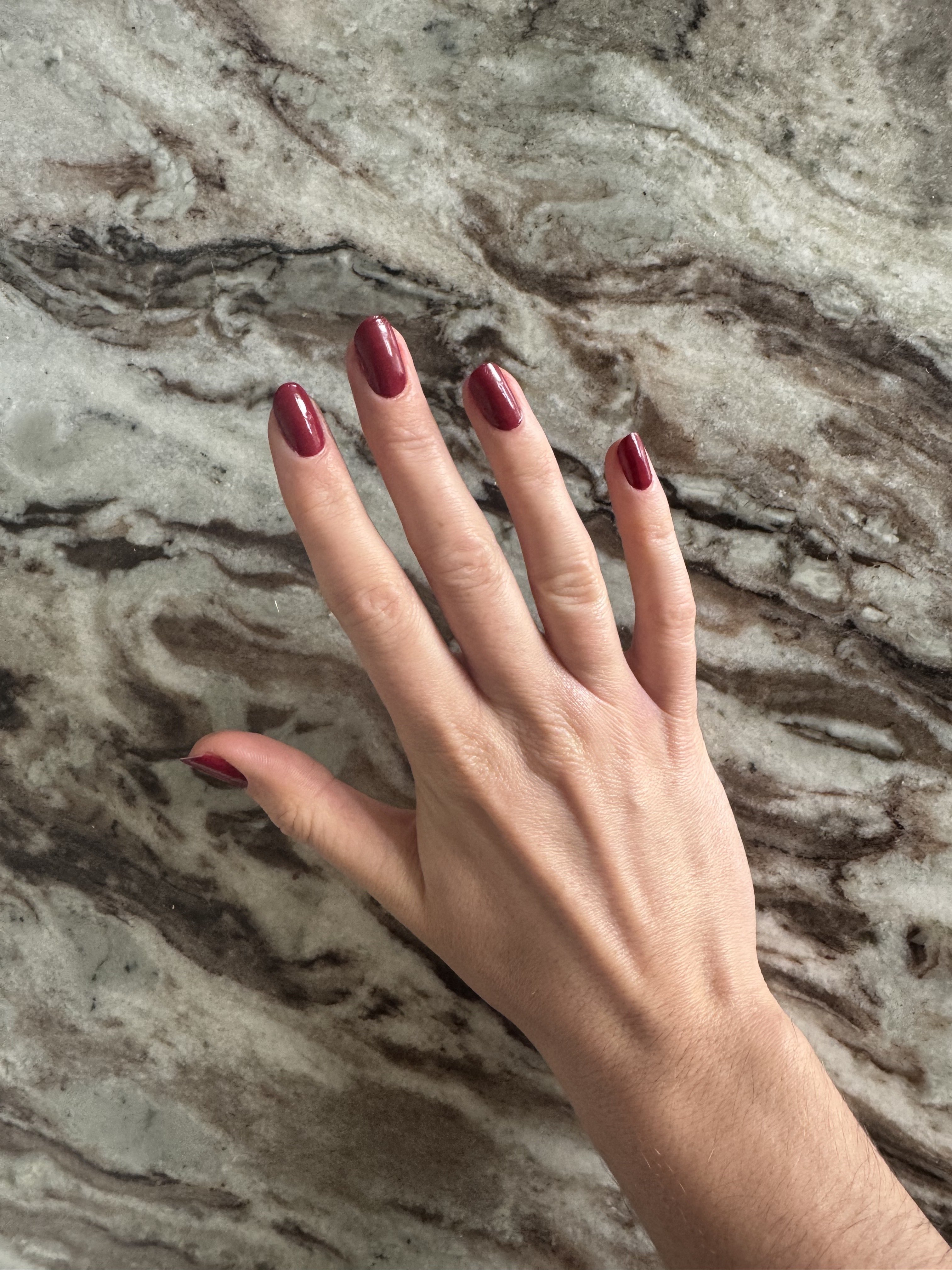 Eleanor wearing OPI Malaga Wine Nail Polish on her nails