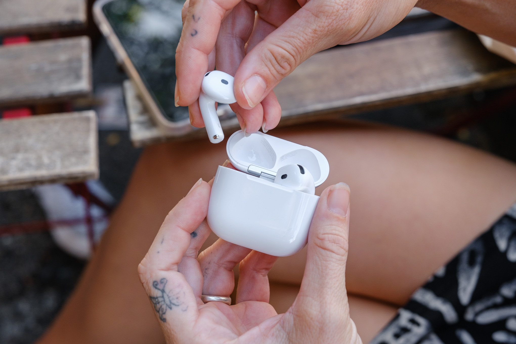 A hands-on photo of Apple’s AirPods 4 wireless earbuds.