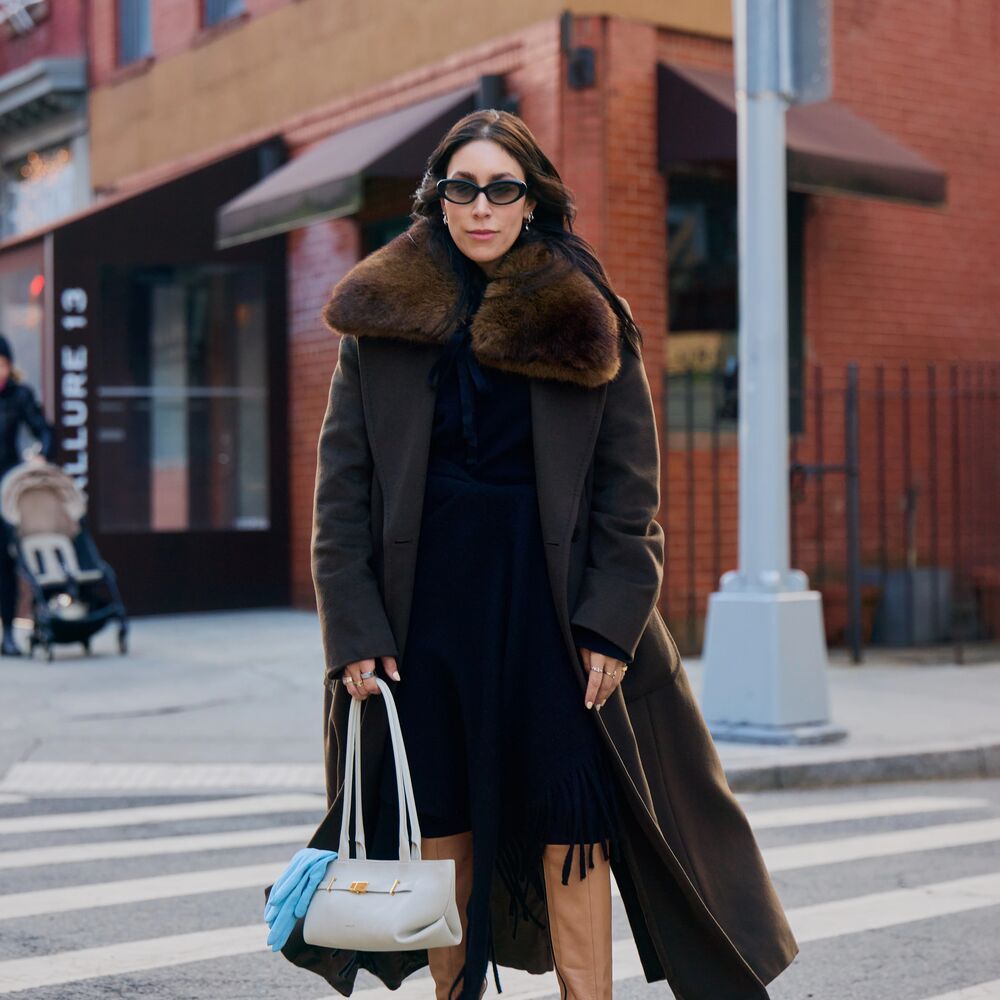 Lauren wears brown mono chromatic outfit with white Demellier east west bag with blue gloves