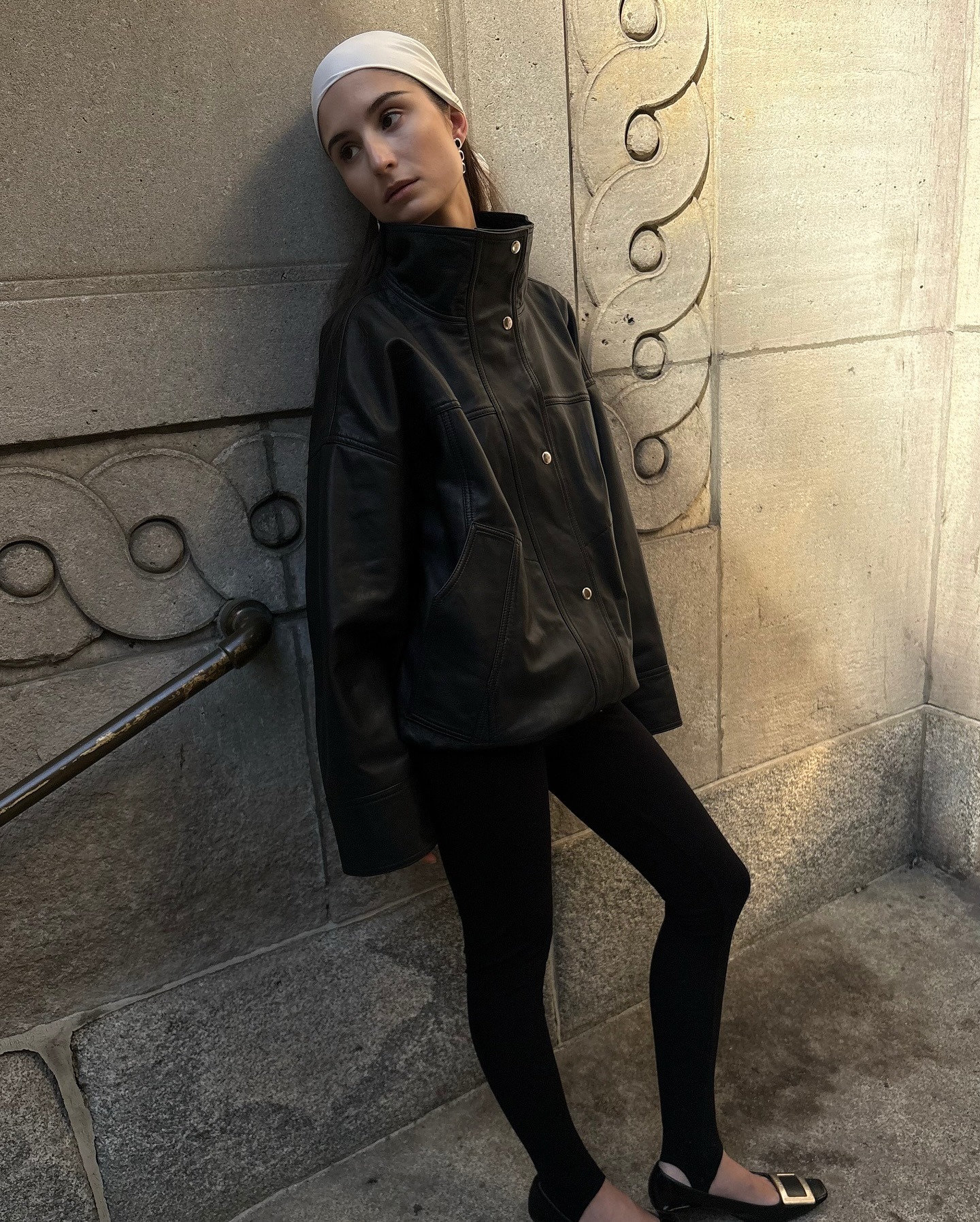 Woman wearing leather funnel neck jacket.