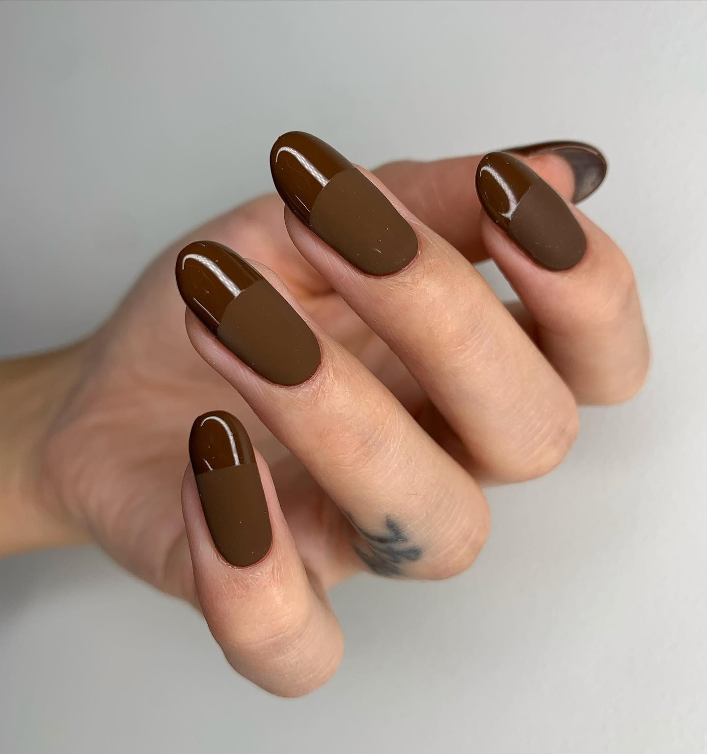 Matte brown nails with glossy French tips.