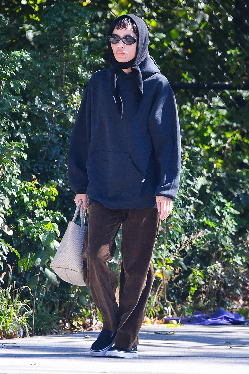 Zo&amp;euml; Kravitz wearing a navy sweatshirt, brown corduroy pants, and black Vans sneakers in NYC