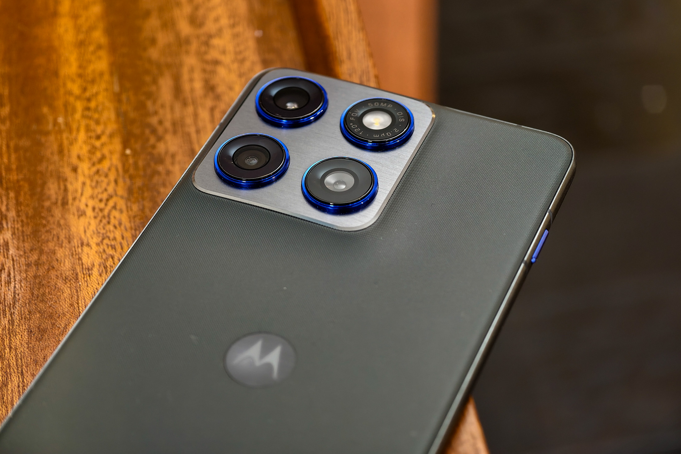 Photo of Motorola Edge 70 lying on a wooden table showing the cameras