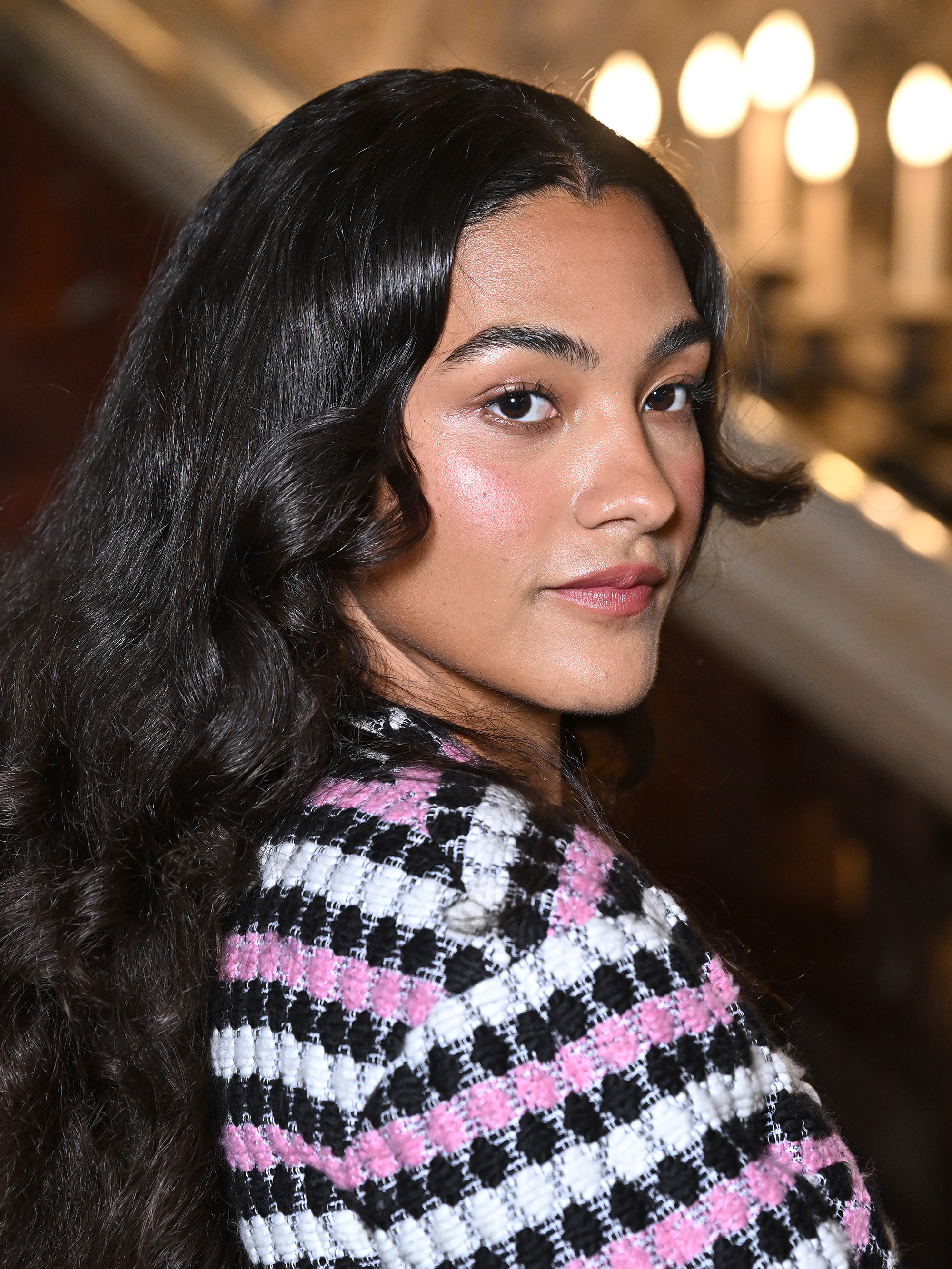 Olivia Dean attends the Chanel Haute Couture Fall/Winter 2024-2025 show during Paris Fashion Week with a dewy complexion and flushed cheeks