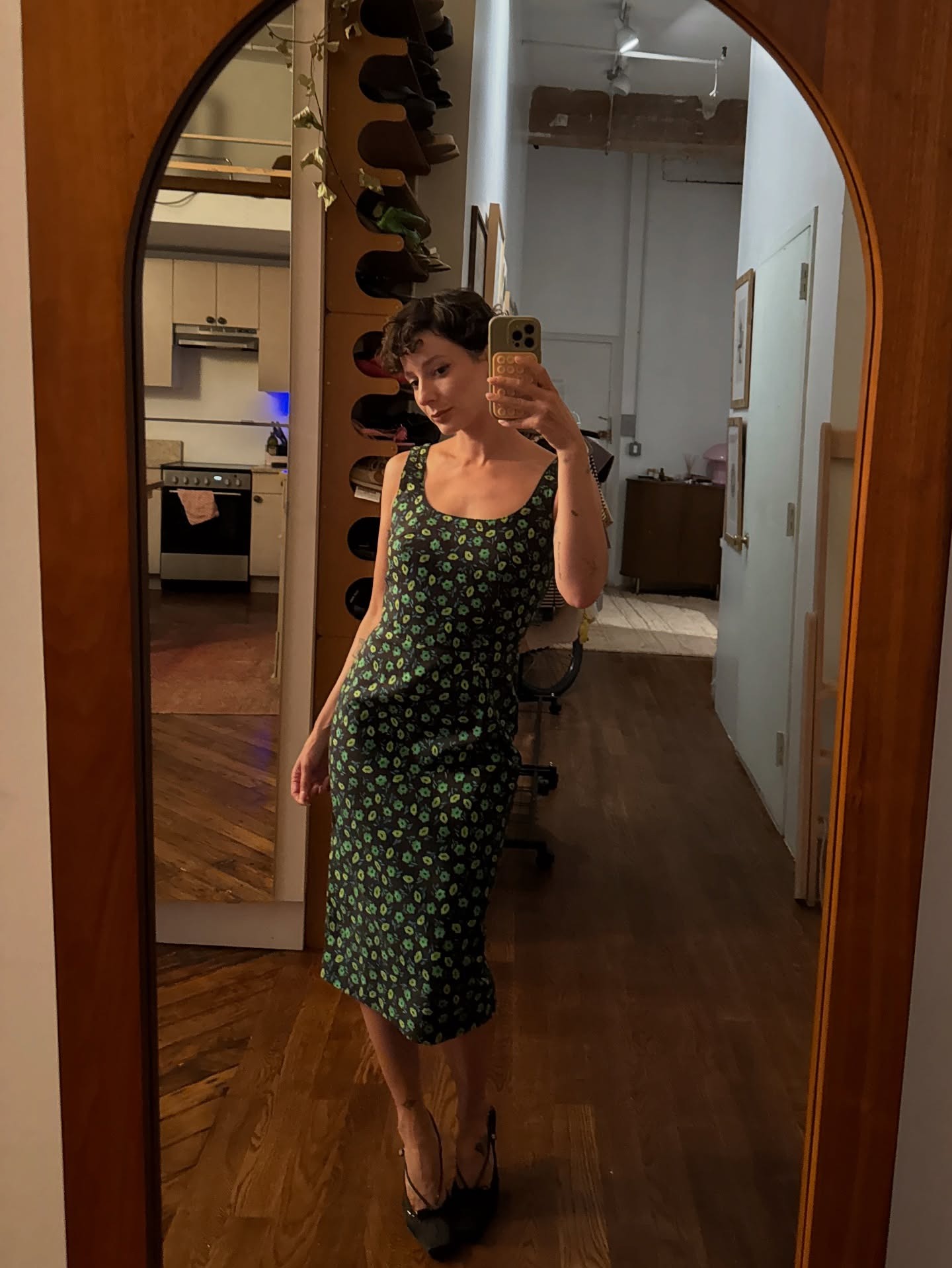 Influencer Alyssa is in a green and black micro floral dress.