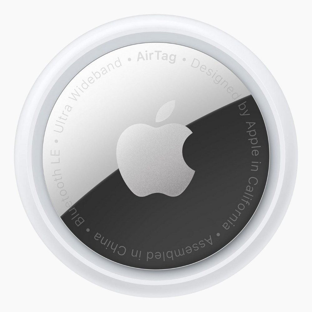 An Apple AirTag on a light gray background.