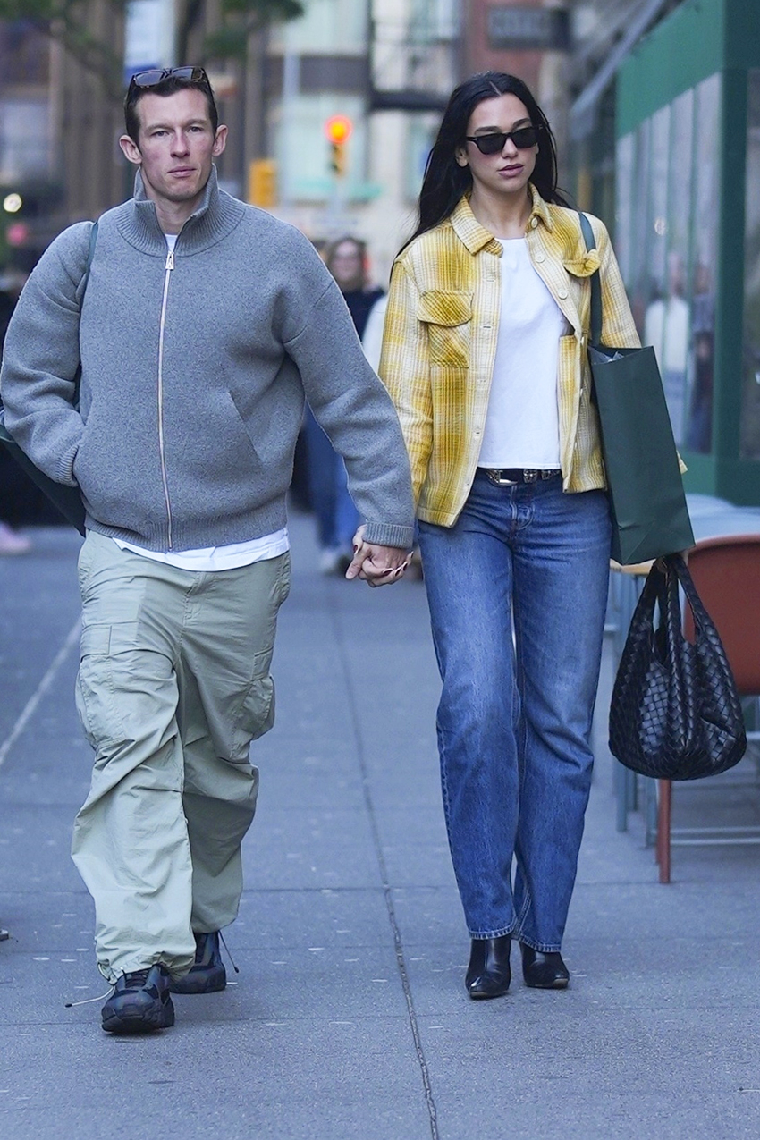 Dua Lipa wearing a yellow plaid shirt and jeans with Callum Turner in NYC