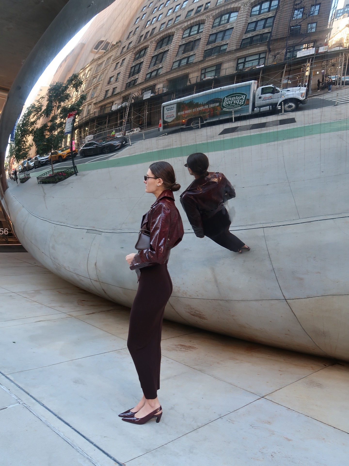 Influencer @cocoschiffer wears burgundy slingback heels with a burgundy leather jacket and a dark brown fitted skirt.
