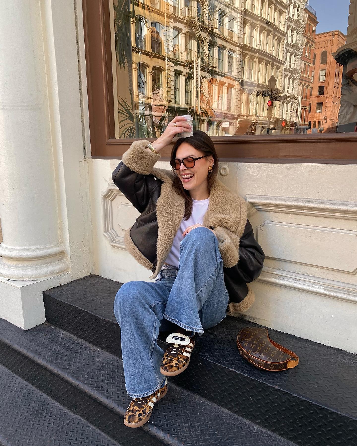 Fashion person Maggie Mccormack @maggie_mccormack wears a leather trainer outfit. She wears a denim jeans, a aviator jacket and white tee.