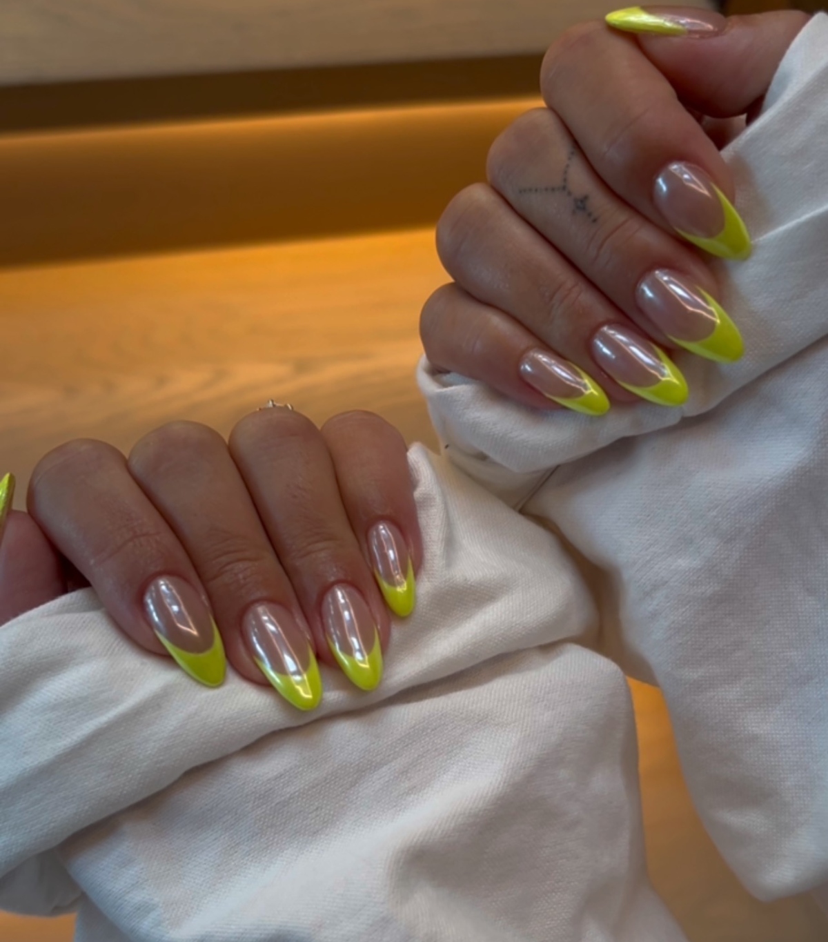 A lime green chrome manicure by Zola Ganzorigt.