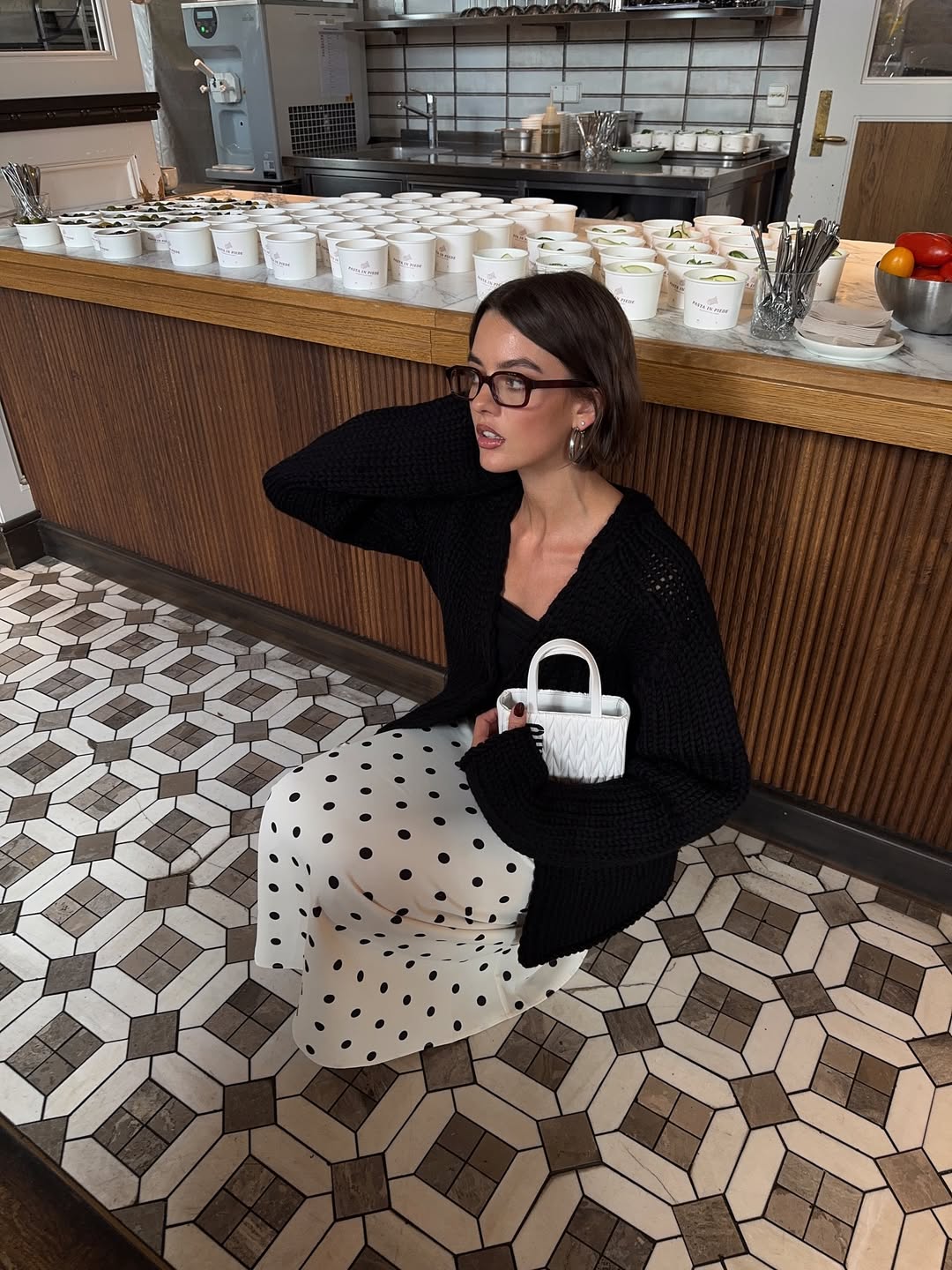 Mary L. Jean poses with a coifed bob and glowy makeup.