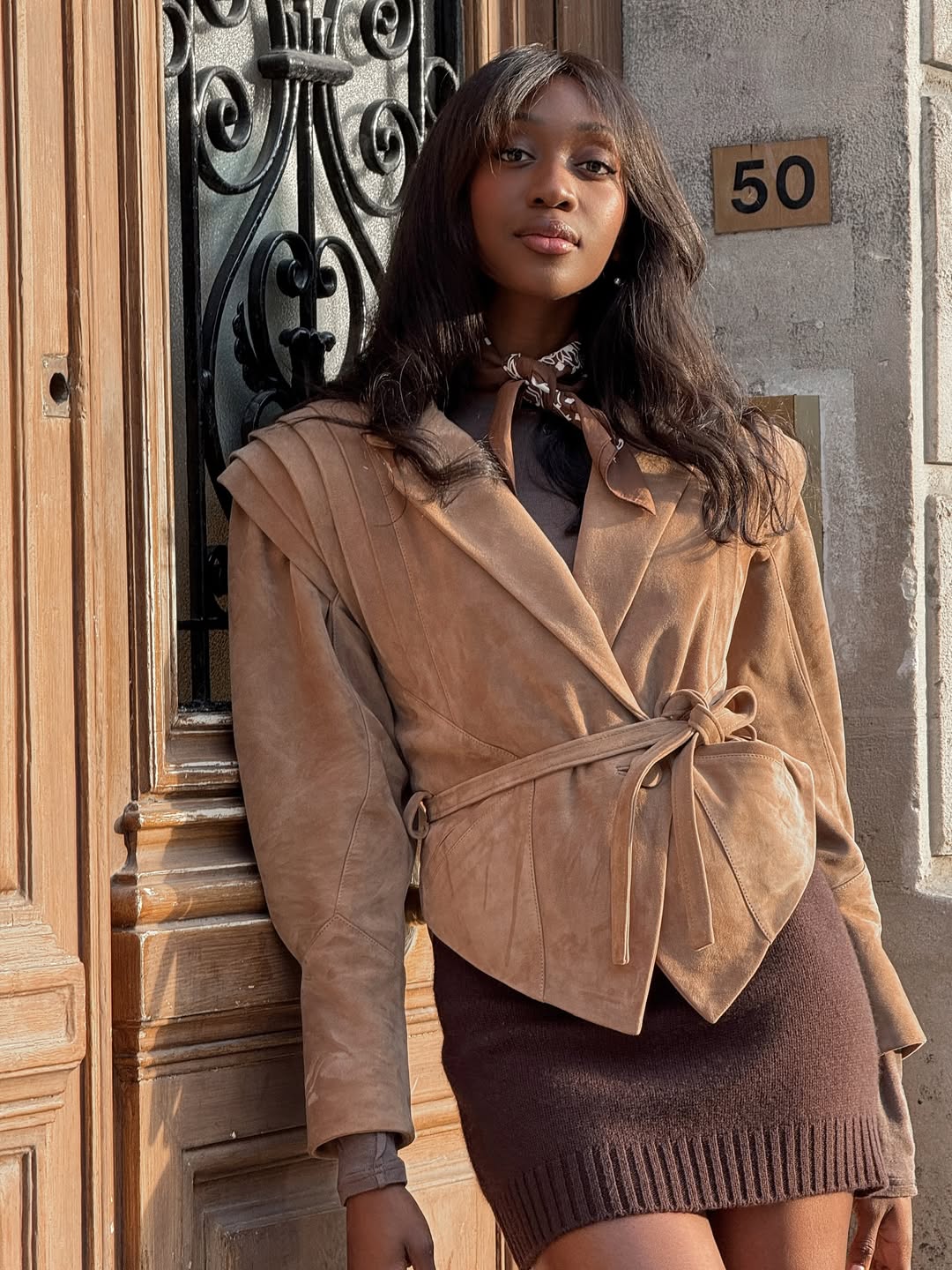 Emmanuelle Koffi poses with tousled curls and a diffused pink lip.