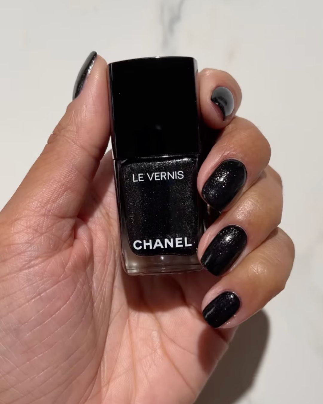 Shimmery black nail polish.